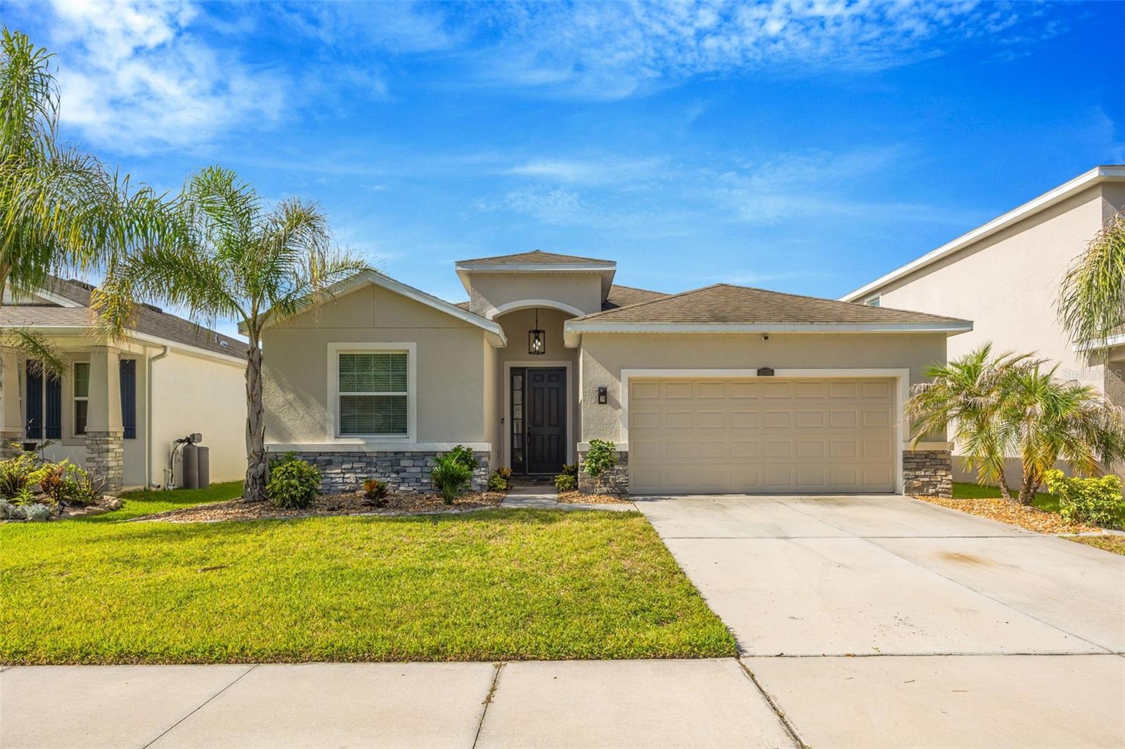 Welcome to this beautifully maintained 4-bedroom, 2.5-bath, 2-car garage home located in the highly desirable Union Park community of Wesley Chapel. Built in 2019 and offering 2,057 square feet of single-story living, this home combines comfort, style, and convenience. Step inside to find a spacious open floor plan featuring laminate flooring throughout with tile in all wet areas—no carpet anywhere! The well-appointed kitchen is the heart of the home, showcasing granite countertops, stainless steel appliances, a large center island with additional seating, abundant cabinetry, and all appliances included, even the washer and dryer. The inviting living area features a cozy gas fireplace and sliding glass doors that lead to a screened lanai overlooking a fully fenced backyard with no rear neighbors, providing the privacy and peaceful setting you've been looking for. The spacious primary suite offers a walk-in closet and a luxurious en-suite bath complete with dual vanities, a garden tub, separate shower, and private water closet. Enjoy resort-style amenities in Union Park, including two community pools, a splash pad, dog park, playgrounds, walking trails, and more. The gated sub-association adds an extra layer of privacy, while HOA fees include both cable and high-speed internet. Conveniently located near top-rated schools, shopping, dining, and major highways, this move-in-ready home is one you won't want to miss!
