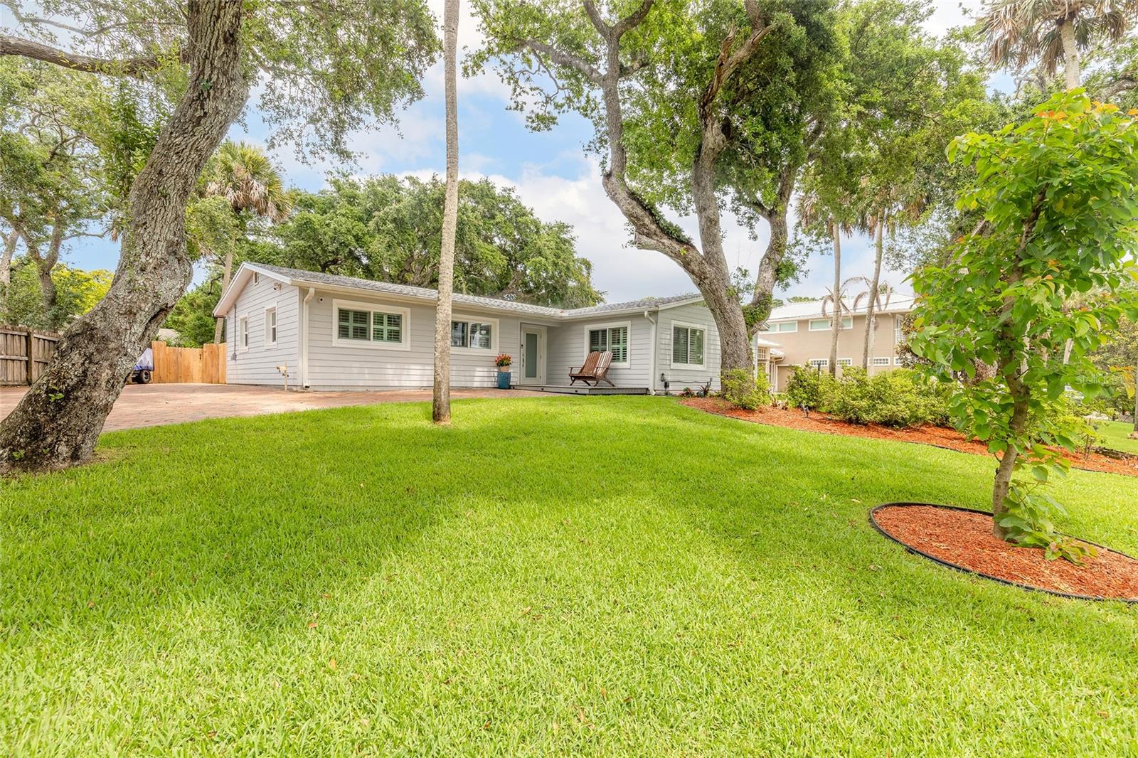 Coastal Retreat just 2 Blocks to the Beach! Beautiful 3-bedroom, 2-bath home on a lush landscaped half-acre lot full of natural mature oak trees at 4181 Saxon Drive. This bright, open-concept home features abundant natural light, a fully screened patio, and exceptional outdoor amenities including a hot tub/cold plunge spa, outdoor shower with instant natural gas hot water, and a charming 12 x 14 foot gazebo.

The oversized paver driveway provides ample parking for vehicles, RVs, boats, and golf carts, with power hookups available for an RV. No HOA restrictions and neighbors are private. Additional features include a whole-home natural gas generator that is only 1 year old. This property is on an elevated lot opposite the river with no flooding concerns. Hurricane windows are installed throughout and a roof was installed in 2024. This is truly a no worry property. Property includes a large shed to store your tools and beach supplies. Shed includes lighting and power. A lawn irrigation system was installed in 2025. All plants damaged from the freeze have been replaced. The backyard is fully fenced with gate access from the driveway. Enjoy the best of coastal, carefree living just a few short minutes to the beach, dining, and shopping.