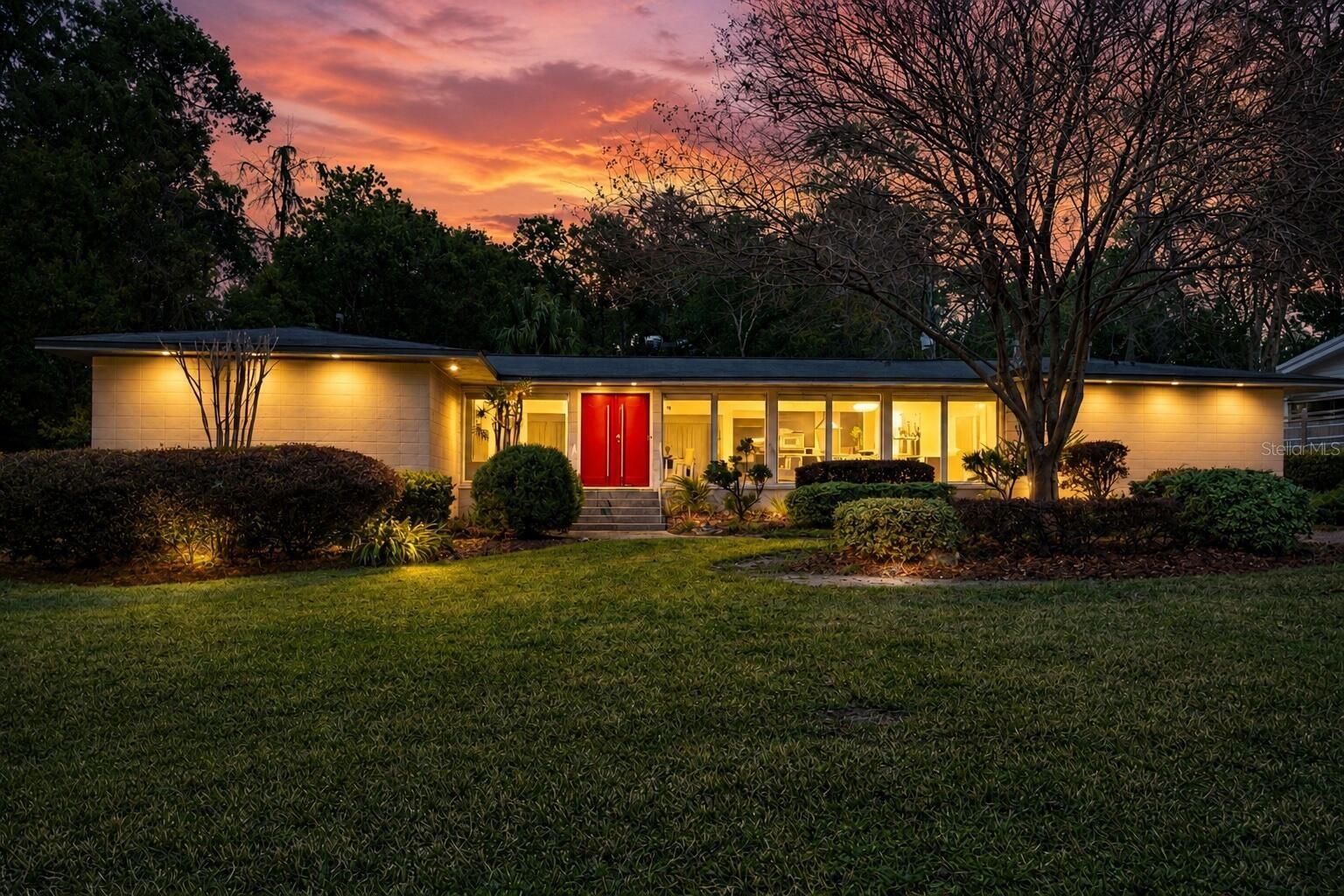 Featured in Gainesville Homes Magazine, this exceptional residence presents a rare opportunity in one of Gainesville's most desirable locations. Just moments from the University of Florida, UF Health Shands, Lake Alice, and Ben Hill Griffin Stadium, the home combines iconic Mid-Century Modern architecture, timeless design, and modern turnkey convenience. Expansive windows and abundant natural light create a living experience that is both distinctive and inviting. Beautifully landscaped grounds, ample parking, and thoughtfully maintained indoor and outdoor spaces provide exceptional functionality for everyday living and entertaining. Enjoy the energy of campus, game days in the Swamp, scenic walks around Lake Alice, and easy access to Gainesville's premier destinations while still enjoying the privacy and tranquility of an established neighborhood. Properties with this combination of architectural significance, condition, location, and lifestyle appeal seldom become available, making this a truly special Gainesville offering.
