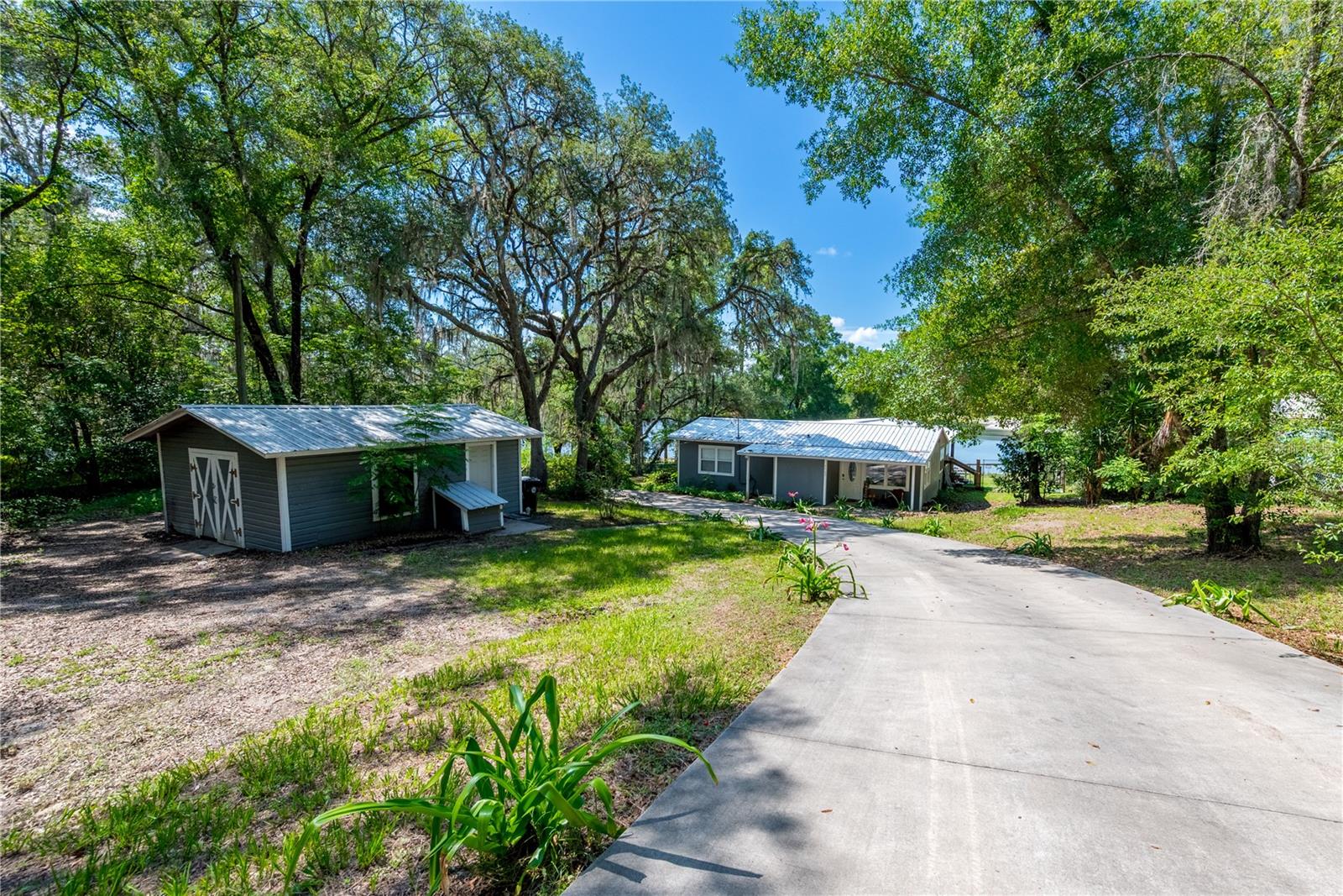 Welcome to your lakefront retreat on beautiful spring-fed Twin Lakes! This charming 3-bedroom, 2-bath home offers approximately 1,600 square feet of comfortable living space in the historic Twin Lakes community near Keystone Heights. Inside, you'll find a spacious kitchen featuring granite countertops and a convenient dining room/living room combo, perfect for everyday living and entertaining. The primary bedroom offers peaceful lake views and direct access to the back deck, creating the perfect place to start and end your day. Step outside to the large covered back deck and embrace the serenity of waterfront living. Enjoy your morning coffee while listening to birds sing, leaves rustle in the breeze, and the gentle sounds of nature surrounding this peaceful lakeside setting. The spring-fed, sand-bottom waters of Twin Lakes are ideal for fishing, boating, kayaking, swimming, and year-round recreation. Situated on an Agricultural Residential (AR) zoned parcel, this property offers the flexibility of a rural lifestyle with room for chickens and other permitted agricultural uses. A large storage shed provides additional space for motorcycle storage, tools, outdoor equipment, and lake toys. Twin Lakes is known for its clear waters, natural beauty, and timeless Old Florida charm. Whether you're looking for a full-time residence, weekend getaway, or investment opportunity, this waterfront property offers a rare opportunity to enjoy relaxed lakefront living while remaining conveniently located near Keystone Heights, Gainesville, Jacksonville, and surrounding areas.