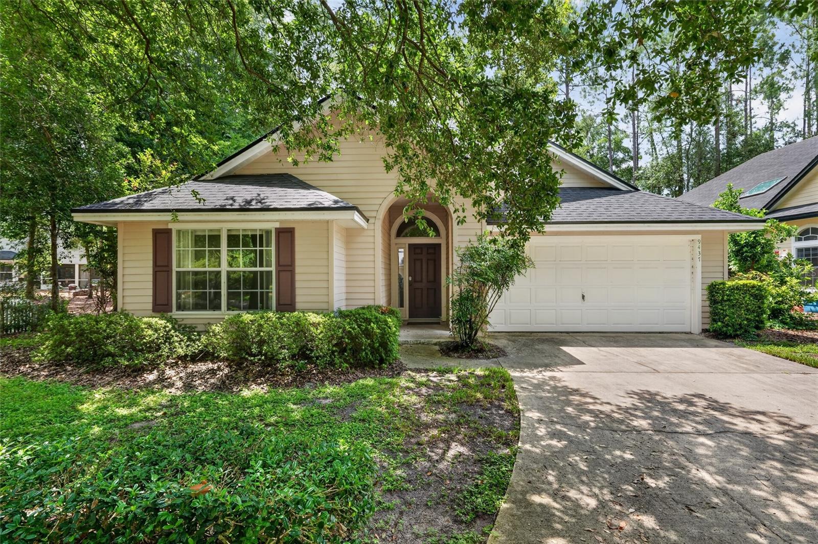 Virtually Staged. Located in the desirable Carlton Court neighborhood of Haile Plantation, this beautifully maintained Jeffrey Wilde-built garden home offers exceptional quality, timeless design, and low-maintenance living. Nestled among mature landscaping and picturesque tree-lined streets, the neighborhood provides outstanding curb appeal while the HOA maintains the front landscaping, allowing you more time to enjoy the Haile lifestyle.  Offering 1,607 heated and cooled square feet, this thoughtfully designed split-bedroom floor plan features 3 bedrooms, 2 baths, and an open-concept layout ideal for everyday living and entertaining. Rich wood flooring extends throughout the home with no carpet to maintain.  A welcoming foyer opens into an expansive great room and dining area highlighted by soaring vaulted ceilings that create a bright, spacious atmosphere. The adjoining kitchen features all-wood cabinetry, generous counter space, and an oversized breakfast bar perfect for casual dining or gathering with family and friends.  Privately situated at the rear of the home, the primary suite enjoys vaulted ceilings and peaceful views of the fenced backyard. The spacious primary bath includes a dual-sink vanity, walk-in shower, and an oversized walk-in closet. Two additional guest bedrooms share a well-appointed hall bath.  Additional features include an indoor laundry room with washer and dryer included, a two-car garage complete with Jeffrey Wilde's signature pegboard wall for organized storage, a durable Hardie Board exterior, and a fully fenced backyard offering privacy for outdoor enjoyment.  Recent upgrades for peace of mind are a 2022 roof and 2024 hot water heater.  Just a short distance from Hampstead Park, residents also enjoy everything Haile Plantation has to offer, including scenic walking and biking trails, two charming village centers with locally owned shops and restaurants, and the opportunity to join Hawkstone Country Club featuring championship golf, swimming, tennis, pickleball, fitness facilities, and dining.  The Haile neighborhood also enjoys all city services including natural gas, city water and sewer as well as convenient to the University of Florida, North Florida and UF Health hospitals, I-75, and zoned for excellent schools.