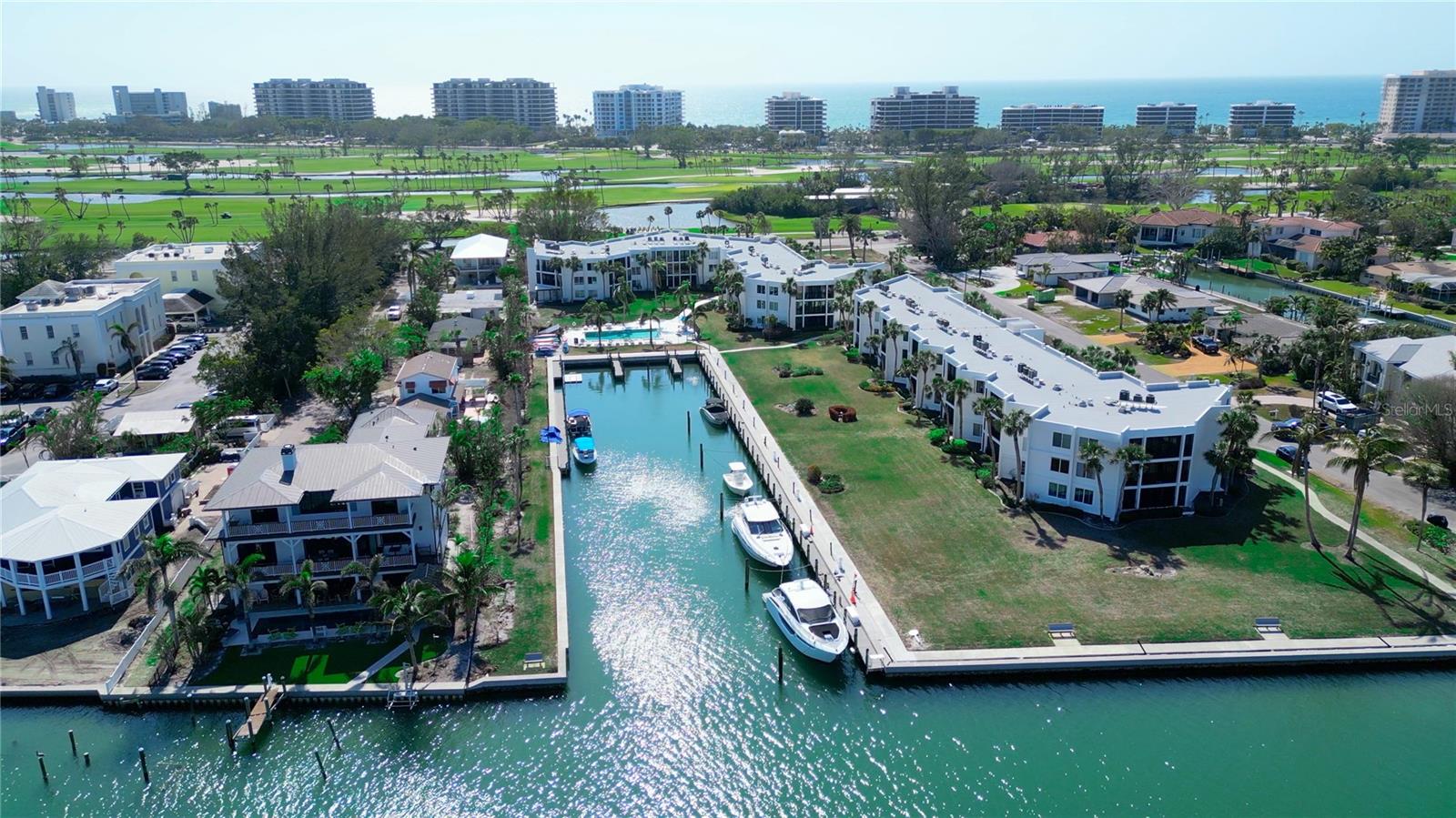 Where can you find an exquisite 3-bedroom waterfront condo on the coveted South End of Longboat Key under $700,000? Discover the ultimate island lifestyle in this beautifully furnished end unit located in the highly sought-after Bay Harbour community. Boasting a desired southern exposure, lower maintenance fees, and a pet-friendly policy, this condo is the perfect blend of comfort and convenience. Even better, the 2023 special assessment of $23,000 has been paid in full, covering a new roof, total building painting, and internal pipe lining. This immaculate home features a bright, coastal interior with a serene, open layout and spectacular bay and pool views through the multiple windows only an end unit can offer. The living room and third bedroom are elevated by beautiful moldings and updated ceilings, while the newer kitchen is a chef’s dream with all under-cabinet pull-out drawers and a clever corner turn-around for maximum storage.  The bathrooms present an excellent opportunity for a new owner to customize and enhance the space with contemporary finishes.
The primary suite is a true retreat, offering breathtaking water views and exceptional closet space with his-and-her built-ins. A unique design feature allows the hallway door to close, transforming the master entry into a private dressing room complete with a full-length mirror. For guests, the hallway is equipped with a pocket door to provide more privacy.  The master bedroom also is equipped with a pocket door. Whether you use the expansive third bedroom for visiting family or as a home office, the versatility of the space is unmatched. Step outside and immerse yourself in the beauty of Sarasota Bay, where you'll enjoy direct access to a kayak launch and optional boat slips just steps from your front door.  

For boating and nature enthusiasts, Bay Harbour is a true gem. Enjoy direct access to a kayak launch and optional boat slips just steps from your front door. With no bridges to Sarasota Bay and just one to the Gulf, you'll have unrestricted access to deep waters for boats up to 42 feet. The remodeled marina is fully equipped with electrical, freshwater, and a fish cleaning station, while the seawall offers frequent visits from dolphins and playful manatees. This unparalleled location is just minutes from world-renowned St. Armands Circle and downtown Sarasota, and it is walkable to the Longboat Key Club, Dry Dock, and Charthouse. Whether you're seeking a permanent residence or a seasonal retreat, this waterfront oasis offers the perfect combination of location, luxury, and lifestyle.