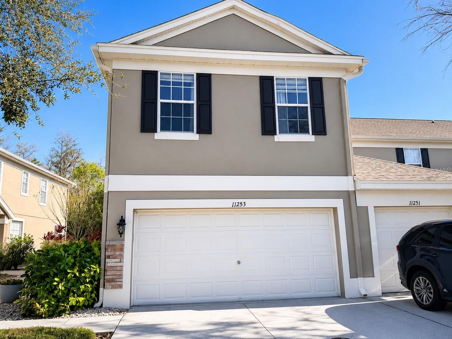 Start your mornings with coffee on the screened porch overlooking a private conservation view — no rear neighbors, just quiet. This end-unit townhome in Windsor Place at Westchase pairs that peaceful backdrop with a bright, open first floor, stainless steel kitchen appliance, and a smart upstairs layout: two bedrooms on opposite ends with a huge flex loft in between. The two-car garage is a rare bonus, outfitted with four overhead racks and built-in cabinetry for serious storage. Add the community pool, top-rated Westchase schools, and quick access to shopping, dining, and the Veterans Expressway, and this is maintenance-free living at its best. Schedule your private showing today.