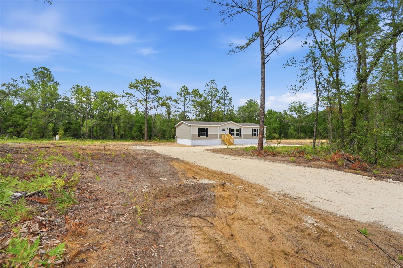 BRAND NEW NEVER LIVED IN BEFORE spacious Double-Wide home located on an Oversized 2 +/- acres double lot located in Williston Highlands with additional field fencing on all four property lines. NEW LIME ROCK DRIVEWAY! Beautiful 3 bedrooms, 2 full bathrooms with brand NEW everything inclusive of septic system, well, electric, AC, field fencing with entrance gate! Spacious Master bedroom includes walk-in closet, along with double vanity sink bathroom and shower bathing areas. Two additional large bedrooms each with roomy closets inside. High quality kitchen with brand NEW Stainless Steel appliances included as well as Large sliding glass doors. Features floor to ceiling cabinetry and multi-purpose kitchen island. Great for cooking, dining, or working! Just a few steps away is a utility area with space to plug in a washer and dryer. Large sliding glass doors that open up to an extended deck.  Ample room to entertain and relax in the Living and Dining rooms. MOVE-IN READY ! Quiet, calming spacious double lot location. Zoned Agricultural rural residential.