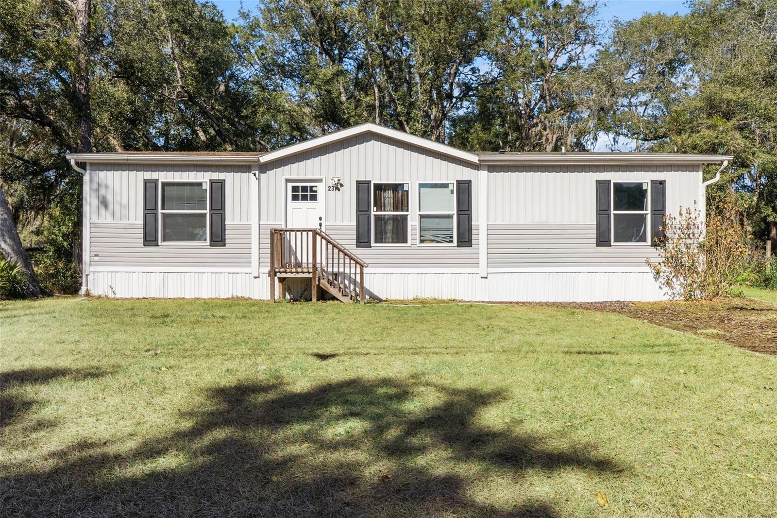 This 2023-built 3 bedroom, 2 bathroom home features an open layout with a modern kitchen, stainless steel appliances, and a center island that opens into the living area. The split floorplan gives the primary bedroom extra privacy with its own walk-in closet and bathroom. A built-in office is perfect for working from home, studying, or gaming. The brand-new central AC unit keeps the home cool and efficient year-round. Enjoy the fully fenced yard and a back deck, great for relaxing or hanging out with family and friends. The home is also just a short drive to Palatka for restaurants and activities, and close enough to Palm Coast and St. Augustine for beaches and shopping.