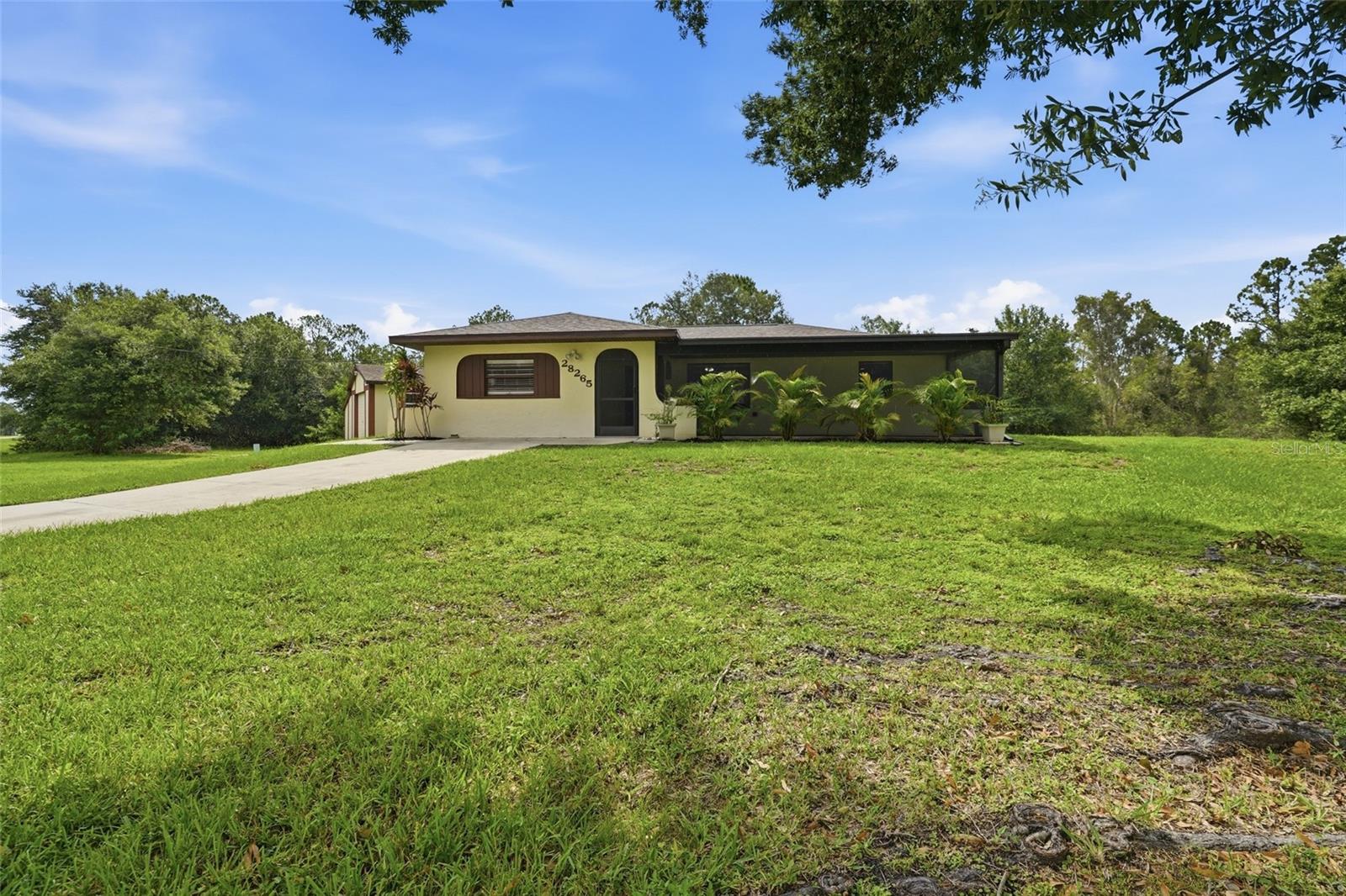 Discover the freedom of country-style living in this 3 bedroom, 2 bathroom pool home situated on an oversized corner lot in Tropical Gulf Acres. With no HOA fees or deed restrictions, this property offers plenty of flexibility for your lifestyle. A bright, open floor plan, spacious outdoor living areas, and a versatile detached garage make this home ideal for everyday living, entertaining, or pursuing your favorite hobbies.

INTERIOR FEATURES
• 3 bedrooms, 2 bathrooms
• Oversized corner lot
• No HOA fees or deed restrictions
• Bright, open floor plan
• Vinyl flooring throughout
• Spacious living room open to the kitchen and dining area
• Large screened front porch
• Laundry room
• Bedrooms have built-in closets
• Third bedroom located on a split floor plan with a nearby full bathroom

KITCHEN FEATURES
• Eat-in kitchen
• All stainless steel appliances
• Surface countertops
• Breakfast bar
• Closet pantry
• Ample cabinet storage
• Open to the living and dining areas

OUTDOOR FEATURES
• Large screened back patio
• Private swimming pool
• Plenty of room for outdoor dining and entertaining
• Oversized corner lot with ample yard space

DETACHED GARAGE / FLEX SPACE
• Detached garage/shed
• Wall-unit air conditioner
• Built-in closet
• Ideal for a workshop, hobby room, home gym, office, man cave, or traditional garage

LOCATION HIGHLIGHTS
• Located in Tropical Gulf Acres
• No deed restrictions
• Easy access to US-41 and I-75
• Convenient to Punta Gorda and Fort Myers
• Close to shopping, dining, parks, and medical facilities
• Short drive to boating, fishing, golf courses, and Gulf beaches

Whether you're looking for a full-time residence, seasonal retreat, or investment opportunity, this pool home offers comfortable living, flexible space, and the freedom to enjoy your property without HOA restrictions. Schedule your private showing today!