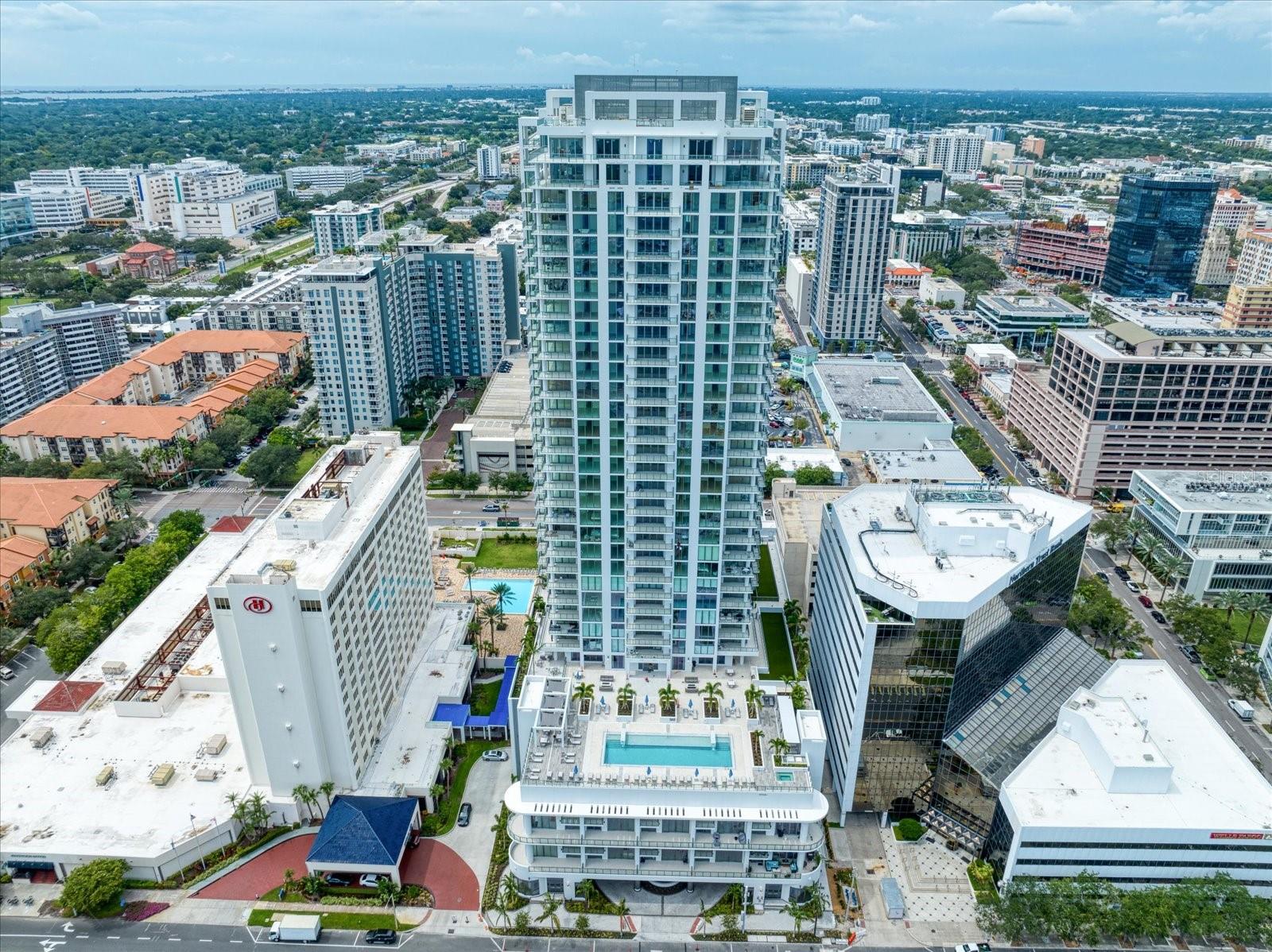 One or more photo(s) has been virtually staged. Be a part of St Petersburg's latest and finest "FIVE STAR LIVING CONDO"! This beautiful building with luxury amenities and walking distance to all of the advantages of downtown living: Restaurants, Shows, Sporting events, Farmer's Markets, Art Shows etc. It is located on a serene street with outstanding open water views of Tampa Bay. This unit is the Premier floor plan with 90 degree water views from the Open Great room area. The 19th floor is above the building on your north side and you can see all the way to downtown Tampa. The unit has 3 bedrooms with private baths, a den/office/media room and full 4th bathroom. This unit has been lavished with upgraded wood porcelain floors throughout the main living areas. $40K in upgrades distinguishes this unit from the others in the building. The amenities deck include a lap style pool with a beach like lounge section plus a separate Spa. The outdoor deck has plenty of lounge areas both in the sun, as well as, covered cabana areas. There is a grilling area with kitchen and tables for personal use or building activities. The Exercise area is complete with an array of machines as well as free weights. The home style Club room is available for personal use or for community activities. Card room area, and public bathrooms are also on this floor. The lobby greets you with a grandiose foyer and sitting area to visit with guests. This unit has assigned parking with 2 reserved spots included, in addition to a storage room outside your front door. MUST SEE and join this amazing community!