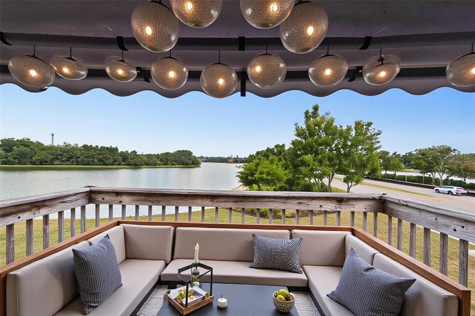 Virtually Staged. WATER VIEW! Spacious townhome END-UNIT with a private screened in patio and balcony overlooking the pond. This 2 Bedroom, 2.5 Bathroom townhome features over 1,200 square feet of living space and it's Move-In Ready.  Furniture is Included. Open floor plan on the main level features a beautiful kitchen with granite countertops and dining room/living room with fireplace. Also on the first floor is the Guest Half Bathroom and laundry room. Porcelain tile flooring throughout the first floor and laminate flooring throughout the second floor. Two spacious bedrooms on second floor both with private bathrooms. The Primary Bedroom has a private balcony that overlooks the large POND. Updates: Freshly Painted Exterior of Building (2026) and AC (2020) Located off of Buenaventura Boulevard within minutes to Buena Ventura Lakes and many shops & restaurants. Convenient and easy access to Florida’s turnpike, Osceola Parkway, FL 417 and approximately 25 minutes away from Orlando International Airport (MCO). This location is situated near Valencia College and major routes.