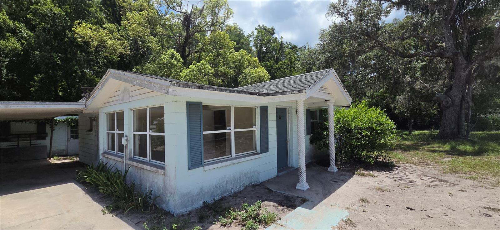 3-bedroom, 2-bath block home sits on a frontage lot and includes an additional buildable frontage lot, plus approximately 6.5 acres of wooded wetlands behind the home that back directly to the J. B. Starkey Wilderness Park. Home is very rough.  Check out the pictures.  No rear neighbors, abundant wildlife, off-road recreation, and a nature trail surrounding the pond that could be restored to its former beauty. Approximately one-half acre surrounding the home is dry and usable, while the remaining acreage provides a peaceful natural buffer. The home features vaulted ceilings, a wood-burning fireplace, utility room, and carport. The fenced frontage has two gated entrances, horses are allowed, and Moon Lake Park is just a short walk away.