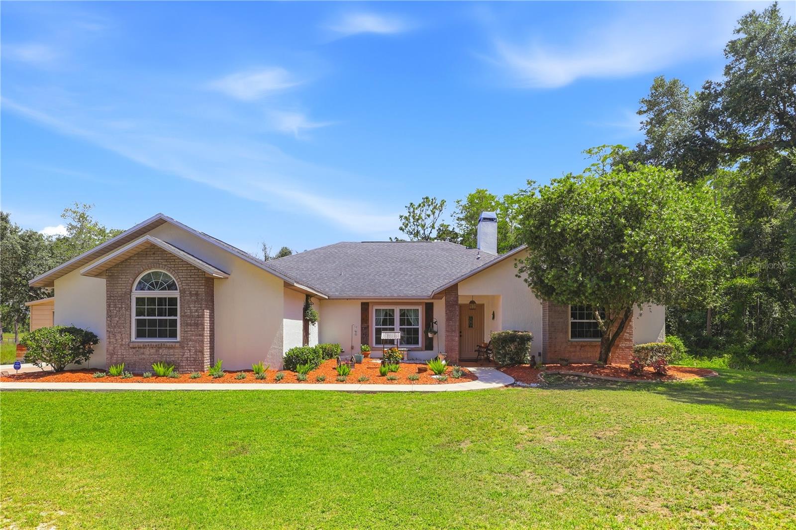 This home provides the perfect combination of space, privacy, and convenience in this beautifully maintained 3-bedroom, 3-bathroom home situated on 2.6 acres. Designed for comfortable living, this home features custom closets in every bedroom, a dedicated laundry room with a utility sink, and a spacious split-bedroom floor plan that offers both functionality and privacy. The inviting living area opens seamlessly to the expansive lanai and screened-in pool and jacuzzi, creating the ideal setting for indoor-outdoor living. A stunning wood-burning fireplace accented with Mexican coral and a custom built-in bookshelf serves as a warm and distinctive centerpiece of the home. The primary suite provides a true retreat, complete with a jetted soaking tub, separate walk-in shower, spacious walk-in closet, and private French doors that open directly to the pool area.Step outside and enjoy your own private outdoor oasis. The screened-in pool and jacuzzi are perfect for year-round relaxation, while the expansive backyard offers endless possibilities for entertaining, recreation, gardening, or simply enjoying the peaceful surroundings. Additional outdoor features include a fire pit, a greenhouse equipped with water and electricity, a separate storage shed, beautiful cypress tress and a 2-car garage. The property also allows for horses and other farm animals, making it ideal for those seeking a rural lifestyle without sacrificing convenience. Roof (2021), Water Heater (2008), Kitchen Appliances (2018), AC (2017)Located near the renowned Wedgefield Golf Course, residents can enjoy convenient access to golf and community amenities. Outdoor enthusiasts will appreciate being just minutes from Hal Scott Regional Preserve and Park, a nature lover's paradise offering miles of hiking, horseback riding, and biking trails, as well as fishing, wildlife viewing, and camping opportunities.Conveniently located just 20 minutes from Orlando International Airport and approximately 40 minutes from Walt Disney World, with easy access to State Road 417 and State Road 528, this exceptional property delivers the tranquility of country living while remaining close to Central Florida's major employment centers, shopping, dining, entertainment, and world-class attractions.