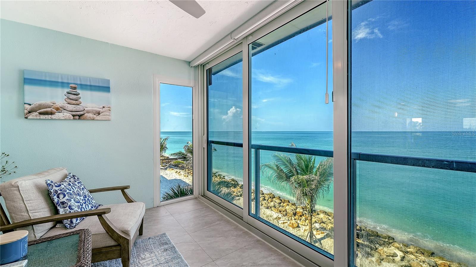 Turnkey furnished and beautifully reimagined in 2024, this top-floor Gulf-front residence at Fisherman's Cove offers a rare opportunity to own one of Siesta Key's most distinctive beachfront retreats. Positioned at the quiet southern end of the island, this one-bedroom residence enjoys unobstructed panoramic views of the Gulf of Mexico from nearly every room, where turquoise waters, sugar-white sand, and breathtaking sunsets become part of everyday living. Thoughtfully renovated throughout, this residence is also the only one-bedroom floor plan in the community offering both a full bath and an additional half bath, providing added comfort and convenience for guests. 
Designed to maximize natural light and waterfront scenery, the open floor plan flows effortlessly from room to room. The Gulf-front terrace has been enclosed, expanding the living space while walls of impact-rated glass frame uninterrupted beach views. Soft coastal finishes, elegant tile flooring, and a fresh, contemporary palette create a relaxed yet refined atmosphere ideal for full-time living, seasonal enjoyment, or investment.
The remodeled kitchen features custom cabinetry, stone countertops, newer appliances, generous storage, and an open design that overlooks the living and dining areas while keeping the Gulf as the focal point. Renovations completed in 2024 include impact windows and sliding glass doors, beautifully updated bathrooms, and quality finishes throughout, while a newer air-conditioning system installed in 2023 adds peace of mind. 
The spacious primary suite enjoys spectacular Gulf views through oversized windows and features an updated en-suite bath. The additional powder room is a rare feature within Fisherman's Cove, allowing guests the convenience of a separate bath while maintaining the privacy of the primary suite.
Nestled between the Gulf of Mexico and Blind Pass Lagoon, Fisherman's Cove offers one of Siesta Key's most desirable waterfront settings. Residents enjoy direct beach access, a heated community pool, fishing pier, complimentary first-come boat slips, and easy access to kayaking, paddleboarding, and boating on Blind Pass leading to Sarasota Bay. The island's south end is also renowned for exceptional shelling and miles of unspoiled shoreline stretching toward Casey Key. 
Ideally located just minutes from Siesta Key Village, waterfront dining, marinas, and downtown Sarasota's renowned Cultural Coast, residents enjoy boutique shopping, acclaimed restaurants, theaters, galleries, Selby Gardens, and year-round entertainment. Whether you're searching for a luxurious beachfront escape, a high-demand investment with one-week rental flexibility, or a move-in-ready Gulf-front residence, this exceptional Fisherman's Cove offering delivers the very best of Siesta Key living.
