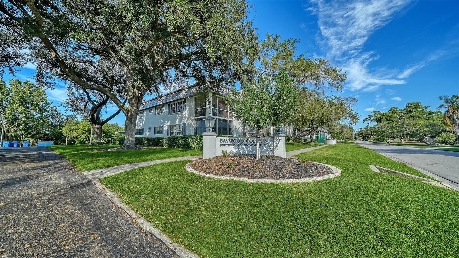 RECENT PRICE ADJUSTMENT - MOTIVATED SELLERS! Rare Opportunity in Prestigious West of the Trail - Welcome to an exceptional corner residence just steps from the Intracoastal Waterway, nestled within the highly desirable Baywood Colony Southwood community. This beautifully updated 2-bedroom, 2-bath end unit is filled with natural light, enhanced by an abundance of windows complemented with elegant plantation shutters throughout.
The front screened lanai has been fully enclosed with sliding glass panels and additional plantation shutters, creating a stylish and versatile space ideal for year-round enjoyment. Inside, the home presents like a model, featuring a stunning open-concept kitchen with granite countertops, a generous breakfast bar, stainless steel appliances, and premium soft-close wood cabinetry accented by under-cabinet lighting. A washer and dryer are conveniently located inside the residence, and elegant tile flooring extends throughout.
Major improvements provide peace of mind, including a new A/C system (2018), a roof replacement by the HOA (2019), and a recently re-plumbed building. This ground-floor unit offers the added convenience of a covered parking space directly behind the residence, along with a secondary private entry from the carport.
Residents enjoy an exceptional Florida lifestyle with access to a heated saltwater pool, tennis and pickleball courts just steps away, and tranquil walks to the Baywood Colony fountain—perfect for taking in spectacular bayfront sunsets. With only 32 residences, the community offers a rare sense of privacy and boutique-style living.
The location is unbeatable: just 2.2 miles from beach access with an easy bike ride, and within walking distance to Phillippi Estate Park—a picturesque 60-acre waterfront preserve offering kayaking, fishing, scenic trails, a playground, a weekly Wednesday farmers market, and a variety of community events including art fairs and concerts.
This pet-friendly, maintenance-free community includes basic cable, exterior and grounds maintenance, roof and window coverage, and pest control—all included in the low monthly fee of $1,273. Best of all, the community is not age-restricted.
Experience the perfect blend of comfort, convenience, and coastal elegance in this truly special Sarasota residence.