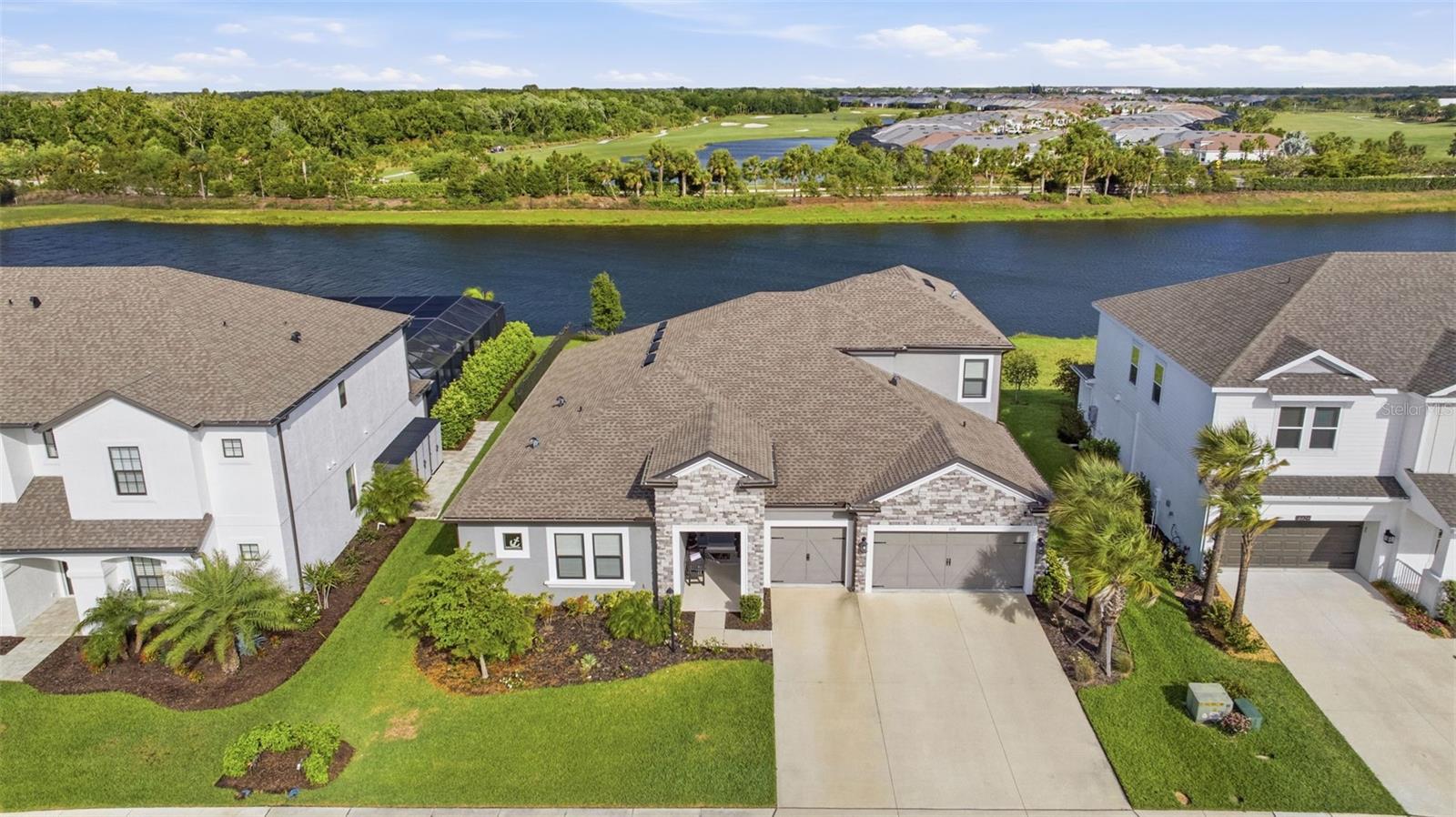 Welcome to this beautifully designed 5-bedroom, 4.5-bath home located in the highly desirable Park East at Azario in Lakewood Ranch. Offering a thoughtful layout and serene pond views with no rear neighbors, this home perfectly blends comfort, privacy, and everyday functionality. The open-concept design seamlessly connects the kitchen, main living area, and a flexible dining space just off to the side—ideal for both everyday living and entertaining. Natural light fills the home, while sliding glass doors lead to a screened-in lanai and fenced backyard, creating a true indoor-outdoor lifestyle. One of the standout features of this home is its highly functional layout, with the majority of the bedrooms conveniently located on the main level. Upstairs, you’ll find a private bedroom, full bathroom, and a spacious loft—perfect for guests, a media room, or additional living space. Step outside to enjoy peaceful pond views with no neighbors directly behind, offering both privacy and a relaxing backdrop. Residents of Park East at Azario enjoy an active, amenity-rich lifestyle with a community pool, sand volleyball and basketball courts, an open soccer field, playground, and dog park. This home is zoned for the newly opened Lake Manatee K-8 School. Ideally positioned within Lakewood Ranch, you’re just minutes from golf, shopping, dining, and everyday conveniences, with easy access to I-75 for a quick drive to Waterside, University Town Center, and the Gulf Coast’s stunning beaches. Lakewood Ranch continues to be one of the most sought-after master-planned communities in the country, known for its vibrant lifestyle and ongoing growth. With exciting new amenities on the horizon at Premier Park, including an expansive aquatic center and 24 pickleball courts, the lifestyle here continues to evolve.