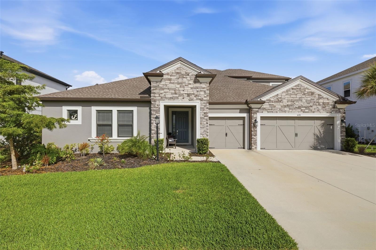 Welcome to this beautifully designed 5-bedroom, 4.5-bath home located in the highly desirable Park East at Azario in Lakewood Ranch. Offering a thoughtful layout and serene pond views with no rear neighbors, this home perfectly blends comfort, privacy, and everyday functionality. The open-concept design seamlessly connects the kitchen, main living area, and a flexible dining space just off to the side—ideal for both everyday living and entertaining. Natural light fills the home, while sliding glass doors lead to a screened-in lanai and fenced backyard, creating a true indoor-outdoor lifestyle. One of the standout features of this home is its highly functional layout, with the majority of the bedrooms conveniently located on the main level. Upstairs, you’ll find a private bedroom, full bathroom, and a spacious loft—perfect for guests, a media room, or additional living space. Step outside to enjoy peaceful pond views with no neighbors directly behind, offering both privacy and a relaxing backdrop. Residents of Park East at Azario enjoy an active, amenity-rich lifestyle with a community pool, sand volleyball and basketball courts, an open soccer field, playground, and dog park. This home is zoned for the newly opened Lake Manatee K-8 School. Ideally positioned within Lakewood Ranch, you’re just minutes from golf, shopping, dining, and everyday conveniences, with easy access to I-75 for a quick drive to Waterside, University Town Center, and the Gulf Coast’s stunning beaches. Lakewood Ranch continues to be one of the most sought-after master-planned communities in the country, known for its vibrant lifestyle and ongoing growth. With exciting new amenities on the horizon at Premier Park, including an expansive aquatic center and 24 pickleball courts, the lifestyle here continues to evolve.
