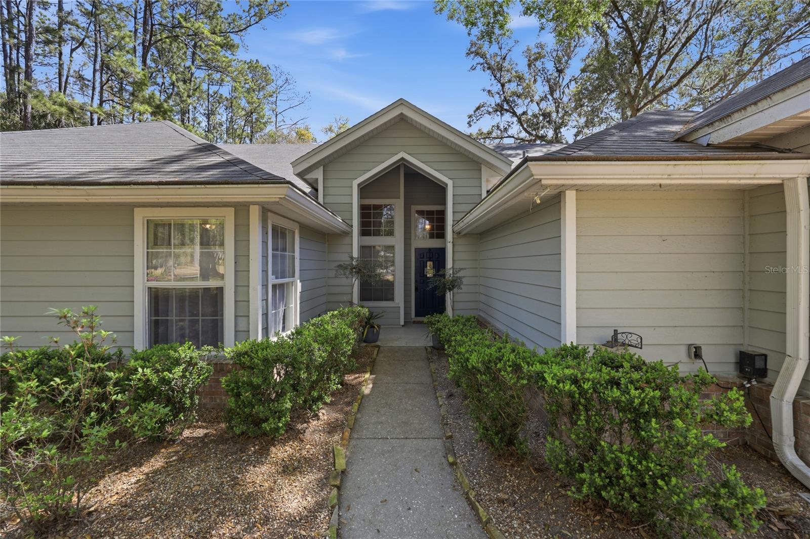 Tucked away on 2.54 private acres in a highly sought-after area of Alachua, this beautifully maintained 4-bedroom, 2.5-bath home offers the perfect blend of peaceful country living and everyday convenience—with NO HOA.
Step inside to discover a thoughtfully designed layout featuring vaulted ceilings, a spacious open-concept kitchen, and both a separate living and family room, ideal for entertaining or relaxing. The home is upgraded with new waterproof lifetime flooring, insulated windows, and stainless steel appliances, creating a modern and comfortable living space. A new Maytag front-load washer and inside laundry room with sink add even more convenience.
The split floor plan provides privacy, with a generous primary suite on its own side of the home, complete with a luxurious en-suite bath featuring a garden tub and separate shower.
Outside, you’ll fall in love with the fully fenced, park-like backyard shaded by gorgeous live oaks and dotted with your own producing ruby red grapefruit, orange, and lemon trees. Enjoy peaceful evenings on the porch swing, watching lightning bugs and local wildlife.
This property is packed with practical upgrades, including a whole-house generator, water filtration and purification systems, gutter guards, and a roof less than 10 years old. For hobbyists or extra storage, there’s both a 2-car attached garage and an impressive 3-bay detached garage.
Located outside city limits yet just minutes from everything, you’re only: 10 minutes to Jonesville, Newberry, and Alachua.  15 minutes to Gainesville.  Within 10 minutes of four Publix shopping centers
Additional features include Clay Electric utilities, Thursday garbage and recycling pickup, fiber optics, and Cox digital cable/internet availability.
If you’ve been searching for space, privacy, and convenience all in one—this exceptional property delivers it all. Schedule your private showing today and experience the charm for yourself!
*Some pictures have been virtually staged.
