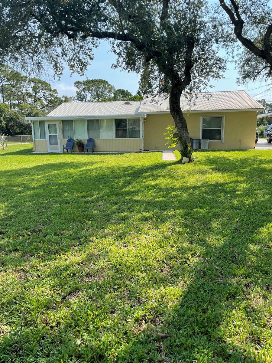 Solid 2/1/1 concrete block home on huge corner lot with fenced yard.  New stainless fridge, range and microwave. Large sunroom/FL  room at rear of house adds square footage.  Living room/dining room combo off the kitchen. Big yard allows for RV parking, boat, or room for a pool and/or outdoor kitchen.  Two large storage sheds in back yard. Trane AC in great shape installed in 2013. Lots of potential for this property!  Central air throughout home except for rear FL room; that has a window unit that is currently inoperable. Updated photos to come soon; estate sale is over now. REDUCED PRICE REFLECTS RECENT APPRAISAL. Measurements approximate; buyer to verify. ;Water: City