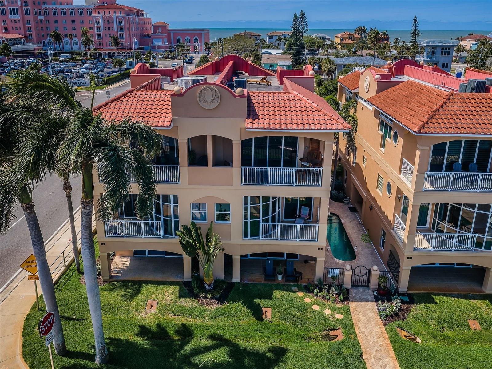 LIVE THE ST. PETE BEACH COASTAL VIBE FROM THIS EXCEPTIONAL ST. PETE BEACH WATERFRONT LOCATION WITH BOAT DOCK AND JUST A 2-MINUTE WALK TO THE BEACH! Enjoy the care-free vacation experience every day in this wonderful 3 bedroom, 3 ½ bath townhome with 3080 sqft of living area, spacious 2-car garage parking and beautiful views of the intracoastal waterway/Boca Ciega Bay and the Don CeSar!  Private gated access to your entry.  Lower level has an excellent multi-purposes storage/gaming/fitness area.  Upper level provides graceful maple floors and gorgeous views of the intracoastal waterway and the Don.  Through pocketing sliding glass doors, your living room opens to a fine 20ft-wide covered balcony overlooking the waterfront – creating a terrific indoor-outdoor living environment.  Open concept designer kitchen features a split multi-level breakfast bar, elegant granite surfaces, alluring maple floors and much more.  Large dining and casual seating area offers tall window views of the Don, and an open balcony with spiral staircase up to an incredible 700 sqft rooftop deck with sweeping 360-degree panoramic views.  The owner’s suite boasts two sizeable walk-in closets and a private covered balcony overlooking the waterfront.  Owner’s bath contains two lovely vanities, a jetted spa tub encased in rich tilework and walk-in glass shower enclosure.  2nd and 3rd bedrooms are en suite with full baths and closet systems.  This townhome lives and feels like a private single-family home – with private elevator, private garage and a quiet private entrance.  Valuable extra’s include a composite dock with water and electric, and a community mini-pool/spa.  Easy walking distance to fine dining, shopping and entertainment.  A terrific commuting location close to the Pinellas Bayway; downtown St. Pete is just 12 minutes away, Tampa International Airport is a 30-minute drive, and you’ll reach downtown Tampa in just 35 minutes. Dimensions are estimates, buyer to verify.