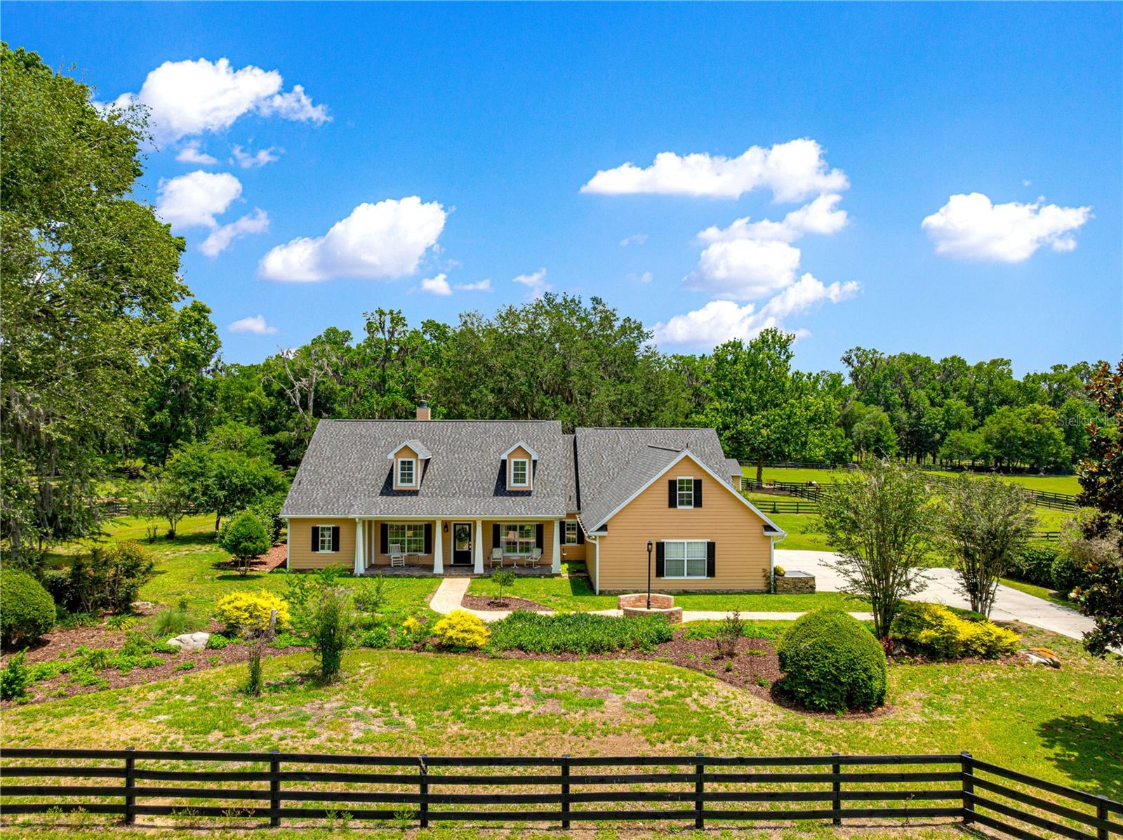 Come see this beautiful 5 acre farm, located just 5 minutes from the Florida Horse Park and Greenway trails in the lovely community of Spring Grove. The property is equipped with automatic entry gate and has direct access to a 2 mile bridle trail right off the property.
 The home features completely remodeled full and half bathrooms with quality fixtures and tiling, including heated flooring in the master bath. The main living area boasts real oak flooring, showcasing the care and maintenance this home has received. 4th bedroom can be used as office/den or take advantage of the bonus room upstairs. The kitchen features granite countertops, a new sink and faucet. Inside laundry room with utility sink and cabinets. The home includes Vivint Home Secuity system.  Mature landscaping with paver walk ways and big grandaddy oaks adorning the entire property. Enjoy entertaining with a spacious back patio, with covered area as well.
Recent improvements include: new HVAC system (2025) New roof and gutters on house and barn (2023) New well pump (2024) New hot water heater (2022)
The property also includes: 3-stall center-aisle barn with a feed room, tack room, fly spray system,wash rack with hot/cold water and water access in each stall. Matted stalls and concrete center aisle. The barn has two sets of doors, allowing easy access to the paddock and the aisle-way. 5 paddocks, 4 with automatic waterers. There is a pole barn that can host more stalls or be used for equipment storage. A spring fed ond sits between the property and adjoining nieghbor. 
Dining room chandelier does not convey.