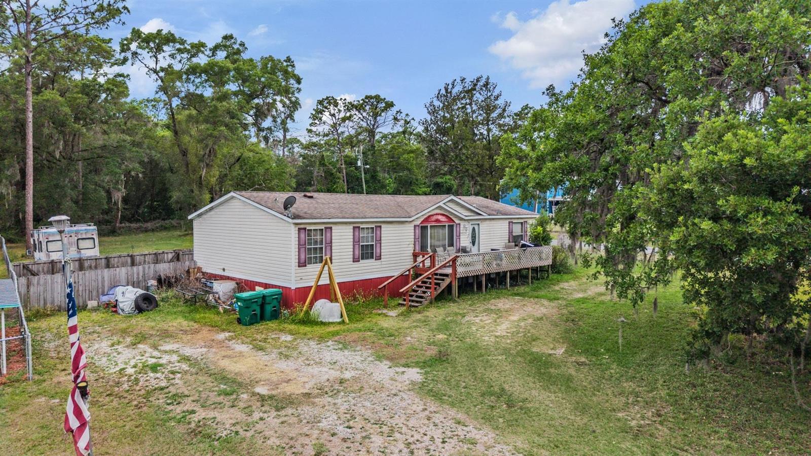 CALLING ALL FLIPPERS AND INVESTORS! BRING ALL OFFERS! Situated on a spacious half-acre corner lot in Hernando, this 3-bedroom, 2-bath mobile home offers plenty of room to spread out both inside and out. The open-concept living and dining area flows seamlessly into a large kitchen featuring ample cabinet and counter space, a center island with seating, and stainless steel appliances.

The split-bedroom floor plan provides added privacy, with a generously sized primary suite and two additional bedrooms ideal for family, guests, or a home office. Outside, the partially fenced yard offers endless possibilities for pets, storage, recreation, or future improvements. A large front deck creates the perfect spot to relax and enjoy the peaceful surroundings, while mature trees provide shade and a natural backdrop.

This property also features solar power, helping keep electric bills low and offering long-term energy savings. In addition, the home is equipped with a commercial-grade air conditioning system designed for enhanced comfort and efficiency year-round.

Conveniently located with easy access to nearby amenities, this property is full of potential and comes with no visible HOA restrictions. Seller is also offering a $1,000 credit toward a new well pump, making this an even better opportunity to add value and make it your own!