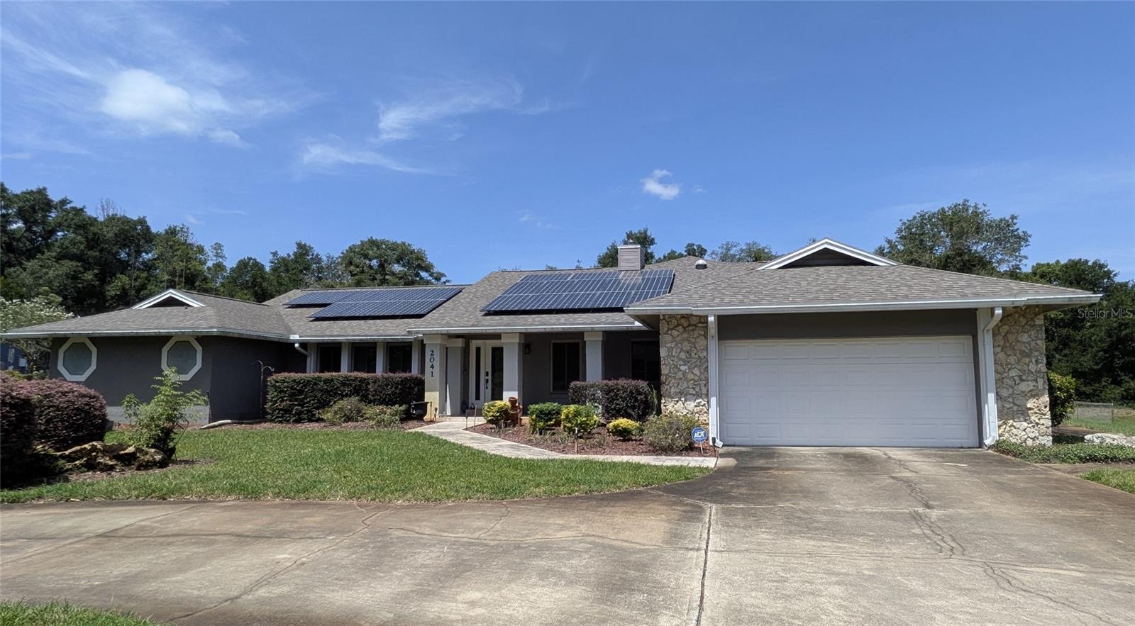 This is your chance to own this rare Central Florida rural country estate sprawling across 2.38 manicured acres. This exceptional split-plan home offers 3 bedrooms, 3 bathrooms, and over 3,400 square feet of meticulously designed living space combining eco-friendly luxury with modern comfort. A grand circular driveway guides you to the entrance of this fully updated smart home, which features a new roof, new energy-efficient windows, and dual A/C systems. The interior boasts an open floor plan with premium stone and wood flooring, recessed lighting, and natural light tubes. The chef's eat-in kitchen is equipped with stainless steel energy-saving appliances, ample cabinetry, a dual pantry, and a cozy breakfast nook. Solar panels provide additional reliable energy. The property also includes an electric car fast charger in the 525 sq ft garage. The expansive master suite serves as a private sanctuary, featuring a flexible bonus room perfect for a yoga studio, nursery, or home office. The spa-like master bath delivers ultimate luxury with dual sinks, a soaking tub, a makeup table, a bidet, and a custom 5-head rain shower. Step outside into your ultimate Central Florida backyard oasis, featuring a fully screened (currently being installed) massive solar-heated saltwater-chlorinated pool. The pool boasts a unique "beach" entry with an umbrella setup, making it the perfect escape for relaxation or entertainment. 
Don’t miss the opportunity to own this below-market-priced estate in the heart of Central Florida.