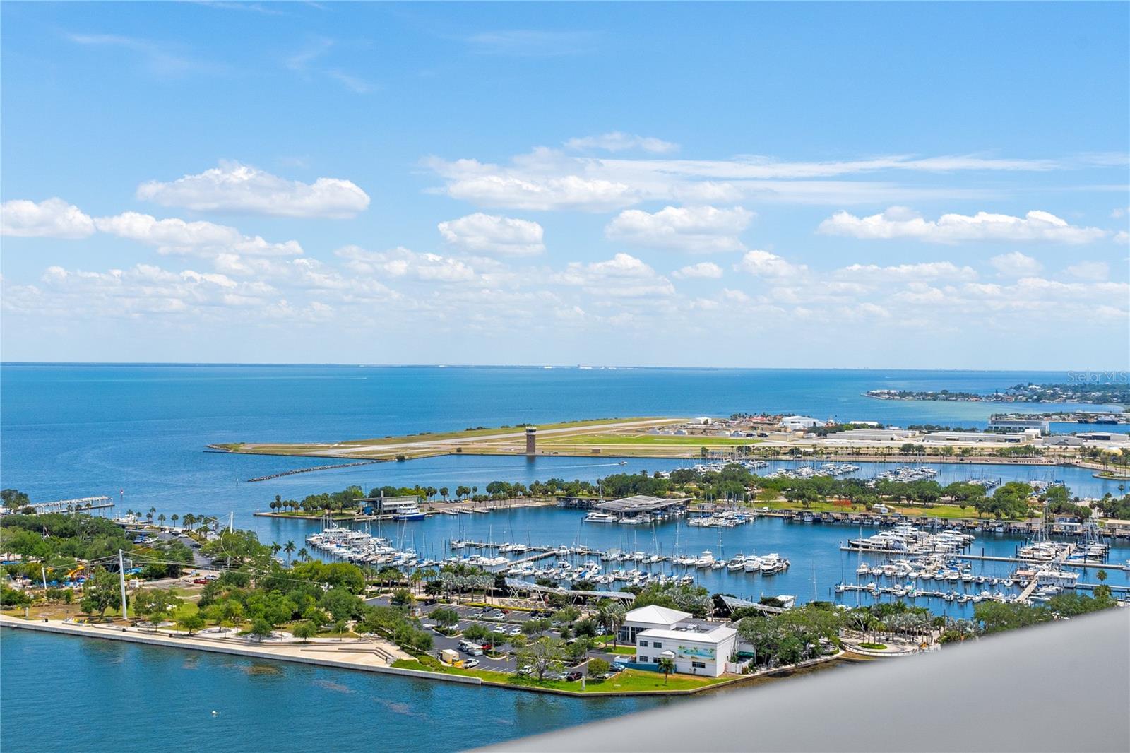A 26th-floor penthouse designed to Manhattan standards, this 4,300 square foot sky residence was taken down to the concrete shell, completely rebuilt into a one of a kind, design forward home with sweeping panoramic views of Tampa Bay, the marina, downtown St. Pete and the Vinoy.  “TRADE CITY CONGESTION AND HIGH TAXES FOR WATERFRONT SOPHISTICATION.” A team of luxury designers, known for their Aspen pedigree, brought their signature craftsmanship and elevated aesthetic to this fully reconstructed waterfront penthouse—creating a rare offering within downtown St. Petersburg’s luxury condominium market. Positioned high above the city skyline, this residence was thoughtfully designed to maximize natural light, unobstructed views, and seamless flow throughout the living spaces. THE PRIMARY SUITE captures breathtaking water views, while the TWO GUEST EN-SUITES perfectly positioned to enjoy stunning sunset views across the city. Globally sourced finishes—impossible to replicate today define the residence. Off the elevator, is your elegant spacious double door private foyer with custom seating and large coat closet. Woodworking crafted by renowned MICHAEL BRIGHT featuring Tidewater Cypress and walnut. Details of CALACATTA STATUARY GOLD MARBLE FROM ITALY and CHOCOLATE TERRAZZO FLOORING abound. Lighting by ONE OF THE BEST LIGHTING DESIGNERS will strategically highlight beautiful works of art a future owner places on the art walls. Top-of-the-line WOLF, Miele, and SubZero, including two wine refrigerators. BEING SOLD FULLY FURNISHED with curated designer furnishings, Knoll pieces like a Mies Van der Rohe daybed & coffee table inspired by the sculptural aesthetic of Ora Ito for Roche Bobois, delivers a true turnkey luxury penthouse. DORNBRACHT fixtures, MELIJAC switches, NANZ hardware, with custom cabinetry and casework throughout. State-of-the-art luxury SMART-HOME AUTOMATION and MULTI-ROOM AUDIO systems. LAUNDRY ROOM with professional-grade MIELE appliances and private caterer’s entrance. PRIMARY SUITE serves as a private retreat featuring dual dressing, closet areas and a grand spa-inspired bath wrapped in flowing Calacatta Statuary Gold marble, dual sinks, large soaking tub plus gracious shower. A thoughtfully designed floor plan separates the bedroom wing from the main entertaining spaces, creating exceptional privacy. THREE BEDROOMS ALL ENSUITE + three and 1/2 bath PLUS AN OFFICE with spectacular water views.  SEE ADDITIONAL FEATURE SHEET.  Overall building is nearing completion of a newly transformed 4th-floor resort-style amenity level with shaded lounge areas, covered gathering spaces, two gas grilling stations with fridge, bar seating, lush landscaping and outdoor seating designed to elevate the ownership experience. The seller has already paid the assessment, allowing the next owner to immediately enjoy the enhanced amenities upon completion. Located in an UNPARALLED LOCATION in ALL of downtown St. Petersburg, overlooking N. Straub Park with lush green spaces and tree-lined sidewalks. Your views are PRIVATE and UNRIVALED in this northern-most location. Truly in the heart of downtown St. Petersburg, this luxury penthouse offers a highly walkable lifestyle moments from waterfront parks, the marina, Beach Drive dining, museums, the St. Pete Pier, and the city’s vibrant arts and cultural scene—delivering an exceptional combination of design, lifestyle, location, and waterfront luxury living. Today is your chance to own this iconic residence.