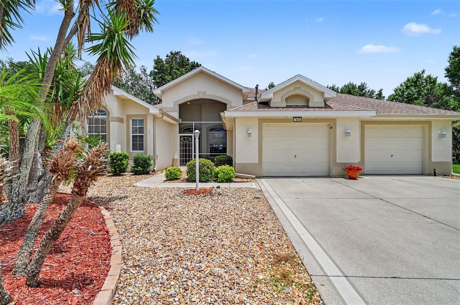 Some photos have been Virtually Staged. Discover the space, privacy, and potential you’ve been looking for in the gated 55+ waterfront Community of Royal Harbor on the Harris Chain of Lakes. Situated on a quiet cul-de-sac and backing to a peaceful wooded setting with no rear neighbors, this thoughtfully designed 2 Bedroom, 2.5 Bath home with a private Office offers 2,163 square feet of heated and cooled living space, an Oversized 824-square-foot Garage, and one of Royal Harbor’s larger homesites at .29 acres. The functional split-bedroom floor plan features a spacious Great Room, Kitchen with adjacent Dining Area, private Office with French Doors, and a Florida Room offering flexible space for relaxing, entertaining, or additional dining. The generous Primary Suite includes two Walk-In Closets and an ensuite Bath with dual vanities, a Garden Tub, and separate Shower. The oversized Guest Bedroom enjoys direct access to a full Bath that also serves visitors, while a convenient Half Bath is located near the Laundry Room and Garage entry. The heated and cooled Florida Room overlooks the expansive backyard and mature trees beyond, creating a peaceful setting to enjoy Florida’s natural beauty. The Oversized Garage provides exceptional space for multiple vehicles, golf cart parking, storage, hobbies, or a workshop area. The roof was replaced in 2021, and the Water Heater was replaced in 2022. This well-designed home presents an excellent opportunity to personalize and update at your
own pace while enjoying one of Royal Harbor’s larger homesites and most desirable settings. Community amenities include a Clubhouse, Social Hall, heated Pool and Spa, Fitness Center, Pickleball, Tennis, Bocce, Shuffleboard, Billiards, Craft Room, Library, Community Dock, Walking Paths, RV/Boat storage, and a full calendar of social activities. Royal Harbor is conveniently located near the Florida Turnpike, shopping, dining, medical facilities, Mount Dora, The Villages, and the waterfront attractions of Tavares, America’s Seaplane City. Schedule your private showing today and discover all that this home and Royal Harbor have to offer.
