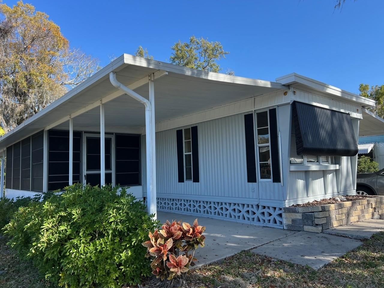 PRICE JUST REDUCED TO SELL IMMEDIATELY ** BEST VALUE IN PALMETTO UNDER 100K, YOU OWN A SHARE OF THE LAND VALUE IN THE
COMMUNITY, AS THIS IS A CO-OP ** SELLER MOTIVATED ** QUIET AND SERENE LOCATION IN SOUGHT-AFTER LEISURE LAKES with LOW HOA FEES ** 2 BEDROOM, 2 BATH with an EXPANSIVE GREAT ROOM PLAN ** RECENTLY UPDATED WITH MODERN TOUCHES AND FRESH
INTERIOR/EXTERIOR PAINT ** COMMUNITY POOL, GATED ENTRANCE AND FANTASTIC VIEWS AMONG THE SOARING TREES & GORGEOUS LAKE ** Look no further than the best value in Palmetto, listed under 100k with 2 bedrooms, 2 full baths while sitting in a gorgeous location inside Leisure Lakes. You will love the newer wood looking low maintenance flooring throughout the family area and huge primary suite. This home has been painted inside and out along with a fresh restore of the kitchen cabinets. Located just outside the family room is a screened patio area where you can enjoy cool Florida breezes and striking sunsets to the west (the patio faces west, carport faces east) Schedule your appointment to view today