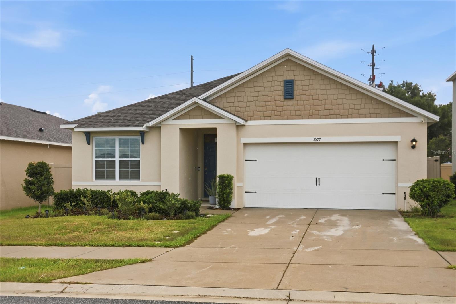 Immaculate, custom-upgraded 2022 "Aria" home on a premium CORNER LOT in Hammock Reserve! This standout property offers a rare combination of turn-key design and move-in convenience. Inside, a beautiful custom shiplap entertainment wall with a built-in electric fireplace anchors the bright, open floor plan. The modern kitchen features granite countertops, a massive island, light cabinets, and stainless steel appliances. All main areas feature tile flooring. The private primary suite includes a walk-in closet and dual granite vanities. Step outside to a covered lanai overlooking an expansive, fully vinyl-fenced backyard—perfect for pets and privacy with no direct rear neighbors.