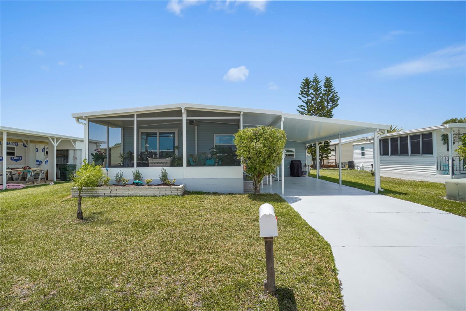 RESORT LIFESTYLE IN A 55+ WATERFRONT COMMUNITY – LOW $175/MO HOA & NO LOT RENT! Located roughly 100 steps from the clubhouse and pools, this fully remodeled cottage in the highly coveted community of Harbor Cove offers peaceful Florida living with fantastic waterfront amenities. The community sits along the scenic Myakka River, and residents enjoy full access to a 90-slip marina situated directly on a protected canal with an easy 2-minute boat ride out to the river. Boat slips are available for just $300/year, delivering direct navigation down to Charlotte Harbor and the Gulf! All furniture and decor stay, making this a beautifully appointed retreat that blends modern upgrades with vintage charm. The home delivers nearly 1,000 sq. ft. of total usable footprint, combining a pristine interior with a spacious 200 sq. ft. screened lanai. The open kitchen has custom butcher block countertops, deep sink, updated cabinetry, and stainless appliances. The bathroom has also been tastefully renovated with a modern vanity and walk-in shower. The primary bedroom is bright and comfortable, while the flexible second bedroom is perfect for guests or a home office. This home has passed a recent 4-point inspection, comes with a seller-provided Home Warranty, and features extensive upgrades to nearly all major components: a new AC and painted driveway (2026); water heater and vapor barrier (2025); siding, 40-ft carport, lanai, and storage shed (2023); membrane roof (2022); and windows, electrical panel, subfloors with 2x4 floor bracing, flooring, and kitchen/bath remodels (2021). The open backyard with partial lake views offers plenty of space to add a large custom deck or patio. Surrounded by tropical foliage, this neighborhood provides daily opportunities for viewing native shorebirds and local wildlife. Enjoy the convenience of boating and fishing right from the community marina, plus full resident access to two heated pools, a hot tub, tennis, pickleball, bocce, a fitness center, and a social calendar. Just moments from pristine Gulf beaches, local dining, shopping, farmers markets, quality healthcare, and MLB spring training stadiums. Call today to view this move-in ready home and secure your place in Harbor Cove!