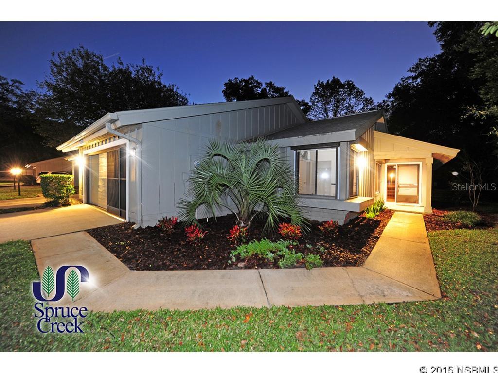 Nice, Largest Floorplan 2BR+Office Condo Villa in exclusive Spruce Creek Fly-In. Single-Story, End Unit with a large yard and serene views. Only unit with Hurricane Shutters for safety and peace of mind. Extensive Landscaping with tropical flowers, evergreens and palm trees reflecting the carefree lifestyle of our community. Sparingly used as a vacation home, this villa shows like new. New HVAC. Sunken Living Room with Fireplace and rustic cedar wood paneling. Wet Bar and dining room with sliding glass doors access to the Patio. Kitchen with Breakfast area also has glass doors to the patio and offers a views of the yard and many trees. Large Master Bedroom with walk-in closet and sliding doors to the patio. Large Master bath with tub. Guest bedroom and Office/Den (can be converted to 3rdbedroom) on same level share the other bath. Washer and Dryer included. The Breakfast Room opens to the patio and grounds, perfect for that Summer Bar-B-Q. Lots of mature trees provide shade and coolness. Community Pool. Two car garage, attic storage space. The Spruce Creek Fly-in is the world's most famous Residential Airpark. 4,000 lighted runway, GPS approach Golf Course, Club, 24-hr patrolled security ;LocationDescription: Condo ;Water: City
