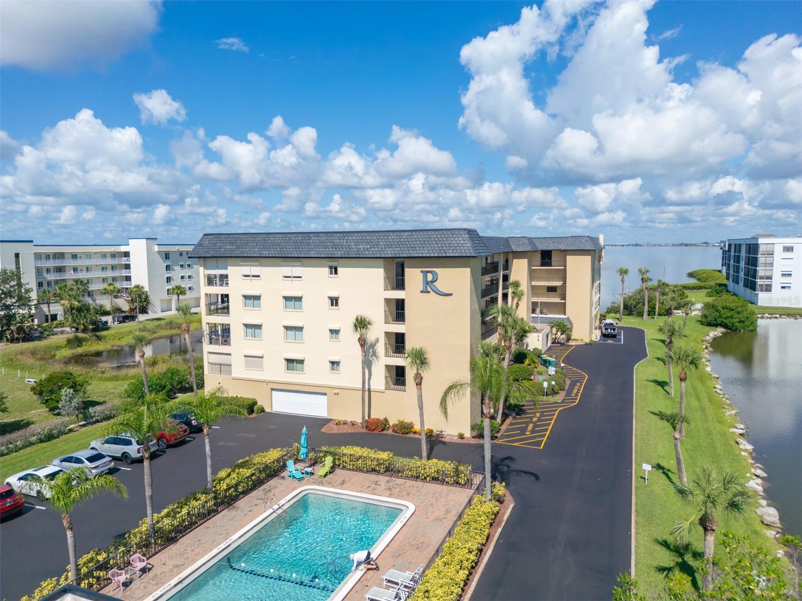 Modern riverfront 2-bedroom, 2.5-bath corner-unit condo in Riverwest, a waterfront community on the Banana River in Cocoa Beach. Natural light from multiple exposures fills this condo, which overlooks the river and a pond from the private balcony. The updated kitchen opens to the living and dining areas and features granite countertops, soft-close cabinets, and a pantry. Light-filled interiors accentuate rich luxury vinyl floors, chic tile, and custom woodwork. The primary suite includes a walk-in closet, dual quartz sinks, and a tiled walk-in shower. Both the guest bath and half bath feature custom quartz vanities. Riverwest amenities include a pool, sauna, private dock, and direct Banana River access. Deeded garage included. SIRS and milestone inspections complete; building is fully compliant. HOA covers cable, internet, sewer, trash, and water. Minutes from the beach, Cocoa Beach Pier, and Port Canaveral. Riverwest delivers the waterfront lifestyle without the waterfront price tag.