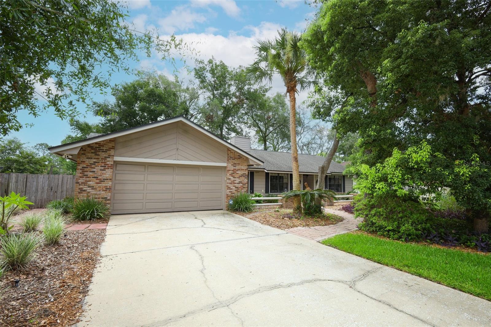 Welcome to 2833 Summer Brooke Way - a custom-built home sitting on a quiet street in Huntleigh Woods, near SR-417/436 and Red Bug Lake Rd. The spacious 2631 sq ft layout offers a 4BR/2BA split plan with generous sized rooms and flex space for an office, gym or play. Character-filled details include cedar beams on the cathedral ceiling, a brick fireplace with cedar accents, French doors, a reading nook, indoor laundry and an oversized 2-car garage. Upgrades: kitchen/baths remodeled with 2" granite counters, SS appliances, new roof/skylights, water heater, knockdown texture, fresh paint in/out, attic stairs. Zoned for Sterling Park Elementary, South Seminole Academy, and Lake Howell HS. FEMA flood Zone X. County water/sewer. Non-smoker. Mature oaks, easy-care landscaping, fenced yard.