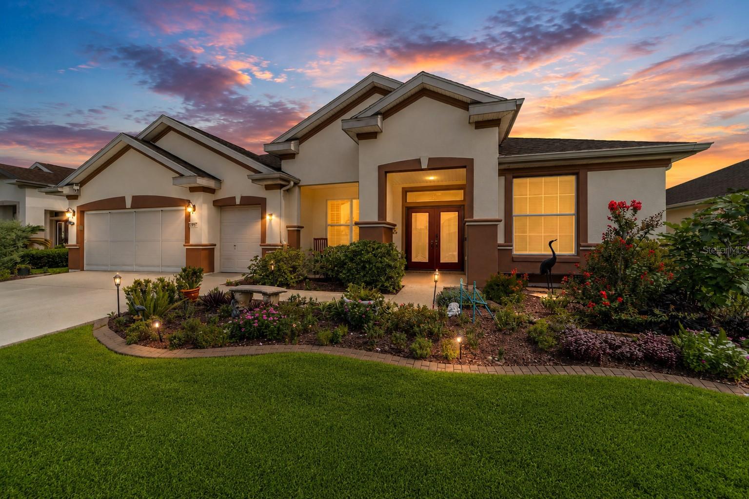 Welcome to the luxurious LEXINGTON, Pulte’s Flagship Model, ideally situated on the 4th Fairway of the prestigious Masters Course in the award-winning Del Webb Spruce Creek Golf & Country Club. This beautifully maintained concrete block and stucco golf-front home offers outstanding curb appeal with a recently refinished driveway and walkway, dedicated golf cart garage, gutters and downspouts, decorative hacienda landscape walls, and a shared irrigation well for economical lawn maintenance.
3 Bedrooms, 2 ½ bathrooms, Large Garage PLUS A 19’ DEEP GOLF CART GARAGE. 
Step through elegant double leaded-glass entry doors into a spacious foyer that opens to formal living and dining rooms enhanced by crown molding, ceiling fans, and 18-inch diagonal tile flooring. The thoughtfully designed split-bedroom floor plan provides both privacy and comfortable everyday living.
The spectacular custom kitchen, completely remodeled in 2022 at a cost of over $37,000, is truly the heart of the home. It features custom cabinetry with pull-out shelving, gorgeous Quartz countertops with a matching scalloped tile backsplash, reverse osmosis water filtration, and newer stainless steel appliances. A custom wet bar with a two-zone beer and wine refrigerator makes entertaining effortless. Adjacent to the kitchen, the spacious family room features plantation shutters, while the bright breakfast nook offers sweeping views of the golf course.
The owner’s suite is a private retreat featuring engineered hardwood flooring, crown molding, plantation shutters, a massive walk-in closet, and an ensuite bath with dual raised vanities, a relaxing soaking tub, glass-enclosed shower, and abundant storage. The guest wing offers two generously sized bedrooms and a beautifully remodeled guest bath (2025), providing ideal accommodations for family and friends.
Outdoor living is equally impressive. Relax year-round in the enclosed lanai featuring new CAT-3 impact-rated glass windows, then step outside to the expansive 50-foot birdcage complete with attractive river rock flooring, soffit lighting, electrical outlets, a cozy fire pit, and ample room for your future spa. Beyond is an open patio that’s perfect for grilling while taking in panoramic golf course views.
The fully paid whole-house solar system dramatically reduces monthly electric costs, adding exceptional value and energy efficiency.

Living here means enjoying the exceptional amenities of Del Webb Spruce Creek Golf & Country Club, a gated 3,250-home active adult community renowned for its resort-style lifestyle. Residents enjoy more than 70 clubs and activities, three swimming pools, three spas, a beautifully appointed clubhouse, fitness center, Liberty Grille Restaurant, four 9-hole golf courses, 12 LIGHTED PICKBALL COURTS AND 7 LIGHTED TENNIS COURTS, bocce, shuffleboard, sand and water volleyball, scenic walking paths, the Lake Vista Gazebo, and beautifully maintained, tree-lined boulevards.
This exceptional golf-front home combines luxury, quality craftsmanship, remarkable energy efficiency, and countless upgrades in one of Central Florida’s premier 55+ communities. Schedule your private showing today and experience the exceptional lifestyle you’ve been dreaming of. Much, Much more...See attached feature sheet for complete list of improvements and upgrades.  See the VIDEO!