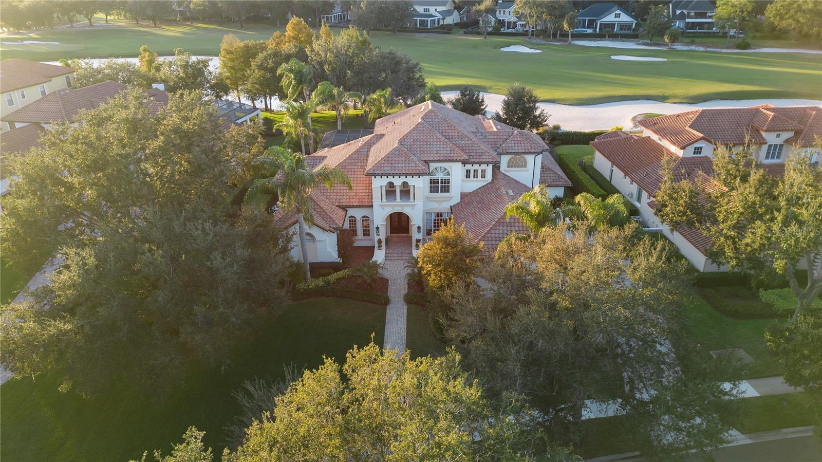 Welcome to this stunning estate located at 6252 Greatwater Dr, on the 18th hole of the pristine Golden Bear Club in Keene's Pointe. This exquisite property boasts a generous 6699 square feet of living space, offering ample room for comfortable living and entertaining.

As you step inside, you'll be greeted by the spacious and airy interior, featuring 5 bedrooms and 6 bathrooms. The primary bedroom offers a luxurious retreat with an en-suite bathroom, providing a perfect sanctuary to unwind after a long day.

The gourmet kitchen is a chef's delight, equipped with high-end appliances, beautiful cabinetry, and ample counter space. It seamlessly flows into the open living and dining areas, creating an ideal setting for hosting gatherings and creating lasting memories with loved ones.

Outside, the property features a beautifully landscaped yard, providing a serene outdoor oasis for relaxation and enjoyment overlooking the 18th hole. The expansive patio area offers an updated outdoor kitchen, and newly resurfaced spa pool. 

Conveniently located in the heart of Windermere, this home offers easy access to a variety of nearby shopping and dinning amenities. Surrounded by A rated schools, and just minutes from the theme parks, this home truly has it all.  

Don't miss the opportunity to make this remarkable residence your own and experience the ultimate in luxury living. Schedule your showing today and envision the possibilities of calling this remarkable property "home."