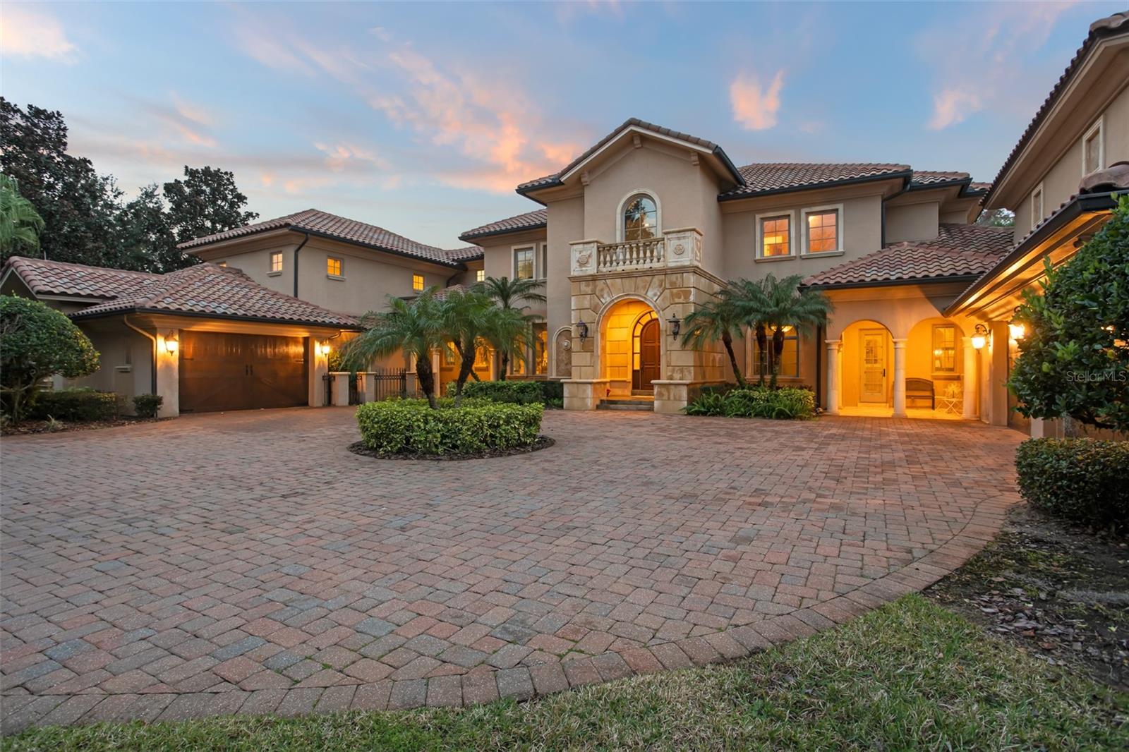 Within the gates of The Reserve at Lake Butler Sound sits a luxurious and spacious Mediterranean-style estate spanning 6,972 square feet on a pristine 1.28 acres and a scenic lakefront setting on Lake Butler.

The estate features a grand dining room with a butler’s pantry, wine room, movie theater, large bonus room, 5 ensuite bedrooms, including an expansive primary suite on the first level, along with 2 additional half bathrooms. Detailed finishes include classic high vaulted ceilings, custom stone work and an elevator. Oversized garages and a circular driveway add to the property's allure.

The outdoor amenities feature a pool, hot tub, outdoor kitchen, and a large dock with boat lift.  This property provides a perfect setting for relaxation and recreation with sunset views that capture a picturesque environment, enhancing the overall appeal of the estate.