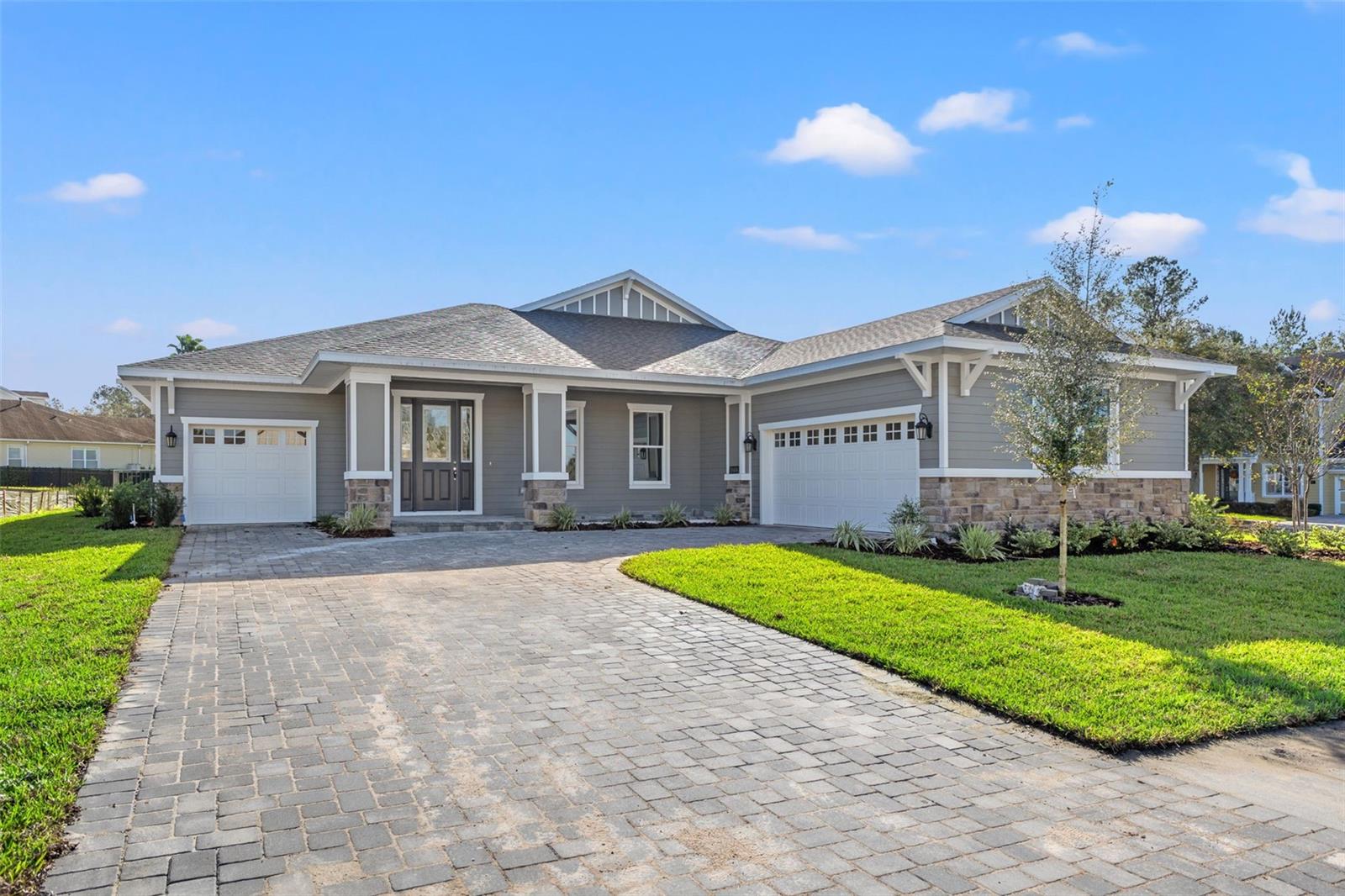 Virtually Staged. Unbelievable price of only $600,000 showcasing 3,026 SF of gorgeous living space and a three car garage.  This beautiful new home built by Spire Homes offers 3,306 SF of living space and is 4,460 SF total under roof. It is located in the sought-after lifestyle community of Southern Hills Plantation. This home features a beautiful architectural design with 3 bedrooms, 3 baths, a large flex room, a massive open living room, cafe space, and a gorgeous kitchen. The chef's kitchen has soft-close cabinetry with crown trim and beautiful quartz countertops. The appliances are stainless steel, and there is a five-burner gas range. One side of the home is reserved for the spacious owner's suite, showcasing a tray ceiling and dual walk-in closets. The luxury primary bathroom features a stylish free-standing tub and a large shower with a frameless glass enclosure. The opposite side of the home features two additional bedrooms, with private access to a shared bathroom. A guest bath in the center of the home is perfect for company. The home features 8' doors throughout, oversized baseboards, and dual-pane windows. Store your cars and toys in the 22' x 20' 2-car garage, which opens to a mudroom. The separate 1-car garage is perfect for your golf cart and extra storage. The paver driveway sets the ambiance for the home, along with the beautiful exterior architectural design elements. A huge 45' long rear lanai is truly magnificent, and it is pre-plumbed with gas and water for a future outdoor kitchen! The lanai provides a relaxing area to watch for deer and birds. Southern Hills Plantation offers a guard-gated entrance, a premier Pete Dye golf course set in rolling hills, a driving range, a chipping/putting green, and a 6-hole par 3 course. The clubhouse is stunning, and the Aquatic and Fitness Center offers a wonderful pool and spa, fitness center, private restaurants, Har-Tru tennis courts, and pickleball! Don't miss this opportunity to own a gorgeous home at a fantastic price in the premier gated community of Southern Hills Plantation.