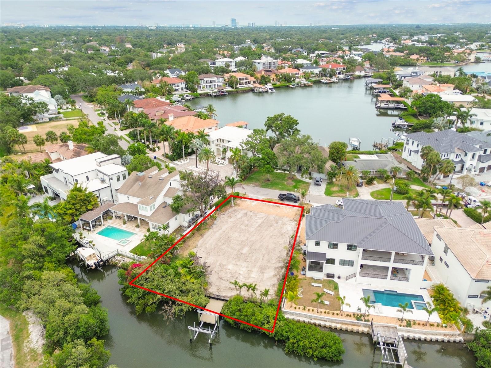 Waterfront living at its finest. Unlock the potential of this exceptional vacant residential lot with open access to Tampa Bay. Perfectly situated on a picturesque canal in one of South Tampa's most desirable neighborhoods and streets. Water access at your fingertips from your private Dock with 20K Capacity Boat lift. This property offers an incredible opportunity to build your dream home in a serene setting while enjoying the vibrant lifestyle that South Tampa has to enjoy. Surrounded by mansions, Spanish Main Street is a highly desirable location. No HOA or CDD fees. This prime site combines luxury living with convenience, as you’re just minutes away from Tampa International Airport, the Westshore Business District, International Plaza, Raymond James Stadium, I 275, Veteran’s Expressway, and thousands of shopping, dining, and entertainment options. Whether you’re looking to create a private oasis or as an investment property, this lot provides the ideal canvas for your vision. Seize this rare opportunity to create your own coastal retreat on beautiful Tampa Bay!