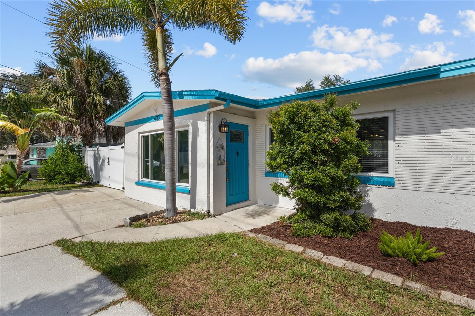 Coastal Living in Tarpon Springs just Steps from the Gulf & Full of Opportunity! Sitting on almost a 1/4 OF AN ACRE, Located directly across the street from the Gulf Waters and less than a mile from Sunset Beach, this charming home offers the perfect blend of coastal living, convenience, and investment potential...all with NO FLOOD INSURANCE REQUIRED!! From the moment you arrive, the circular driveway, tropical landscaping, and stunning foxtail palms set the tone for this light-filled, move-in-ready home. Inside, you’ll find a bright, open layout with spacious living and dining areas, a functional kitchen with solid-surface countertops, stainless-steel appliances, breakfast bar seating, and plenty of cabinet space, plus a separate, indoor laundry room! Outside is where the possibilities really shine! The HUGE PRIVACY FENCED BACKYARD offers plenty of room for a pool, outdoor entertaining space, garage, or additional parking pad, while the large 10x16 storage shed provides extra room for beach gear, bikes, and tools. Major updates include a 2019 ROOF, 2021 A/C, and some hurricane-impact windows.  Love the outdoors? You’re minutes from Sunset Beach, Fred Howard Park, the Pinellas Trail, downtown Tarpon Springs, and the famous Sponge Docks, where you’ll enjoy boating, kayaking, fishing, festivals, restaurants, live music, and waterfront sunsets year-round.  Previous owner reported that she confirmed with the City of Tarpon Springs that the property is eligible for connection to the city sewer, offering flexibility for future improvements such as adding a pool.Whether you’re searching for a primary residence, vacation home, or investment opportunity, this property delivers the Florida lifestyle you've been dreaming about. Gulf breezes, beach days, and endless potential...this is Tarpon Springs living at its best.