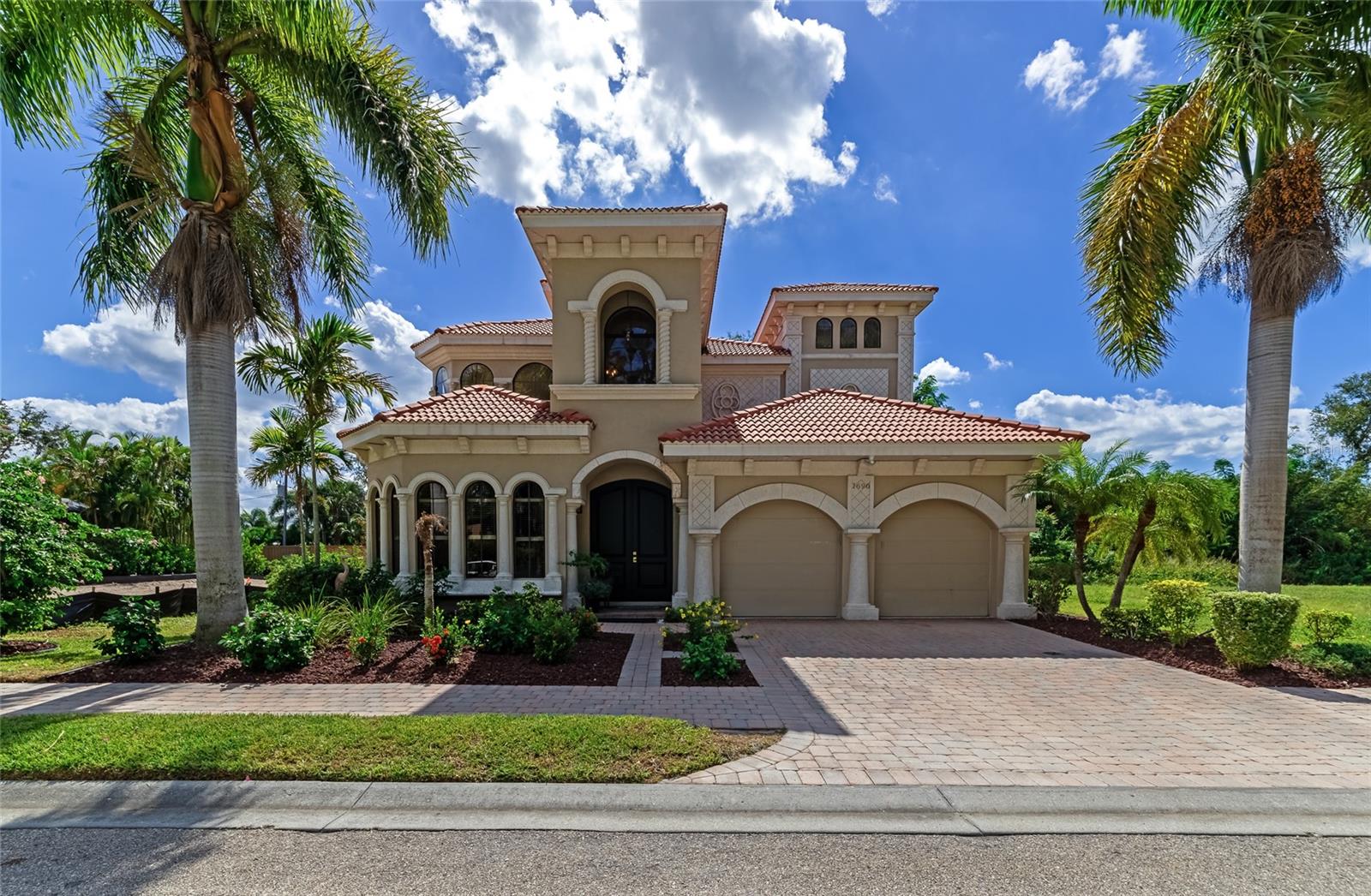 Don’t miss this stunning Mediterranean-Tuscan-style residence, perfectly situated just steps from the Intercostal.  This gated Sarasota estate home located in Portofino on the Bay includes its own DEEDED boat slip and remote controlled 10,000 LB. boat lift.  Experience being near waterfront without the need for any flood insurance or stress of flooding, but still have your boat in your backyard with Bay access. This model-home-ready property features a private feeder dock slip, offering effortless access to the open water for boating. The Bay opens almost directly across from the newly opened midnight pass with Caribbean worthy turquoise water. 
Inside, the home has been completely renovated with top-of-the-line appliances and designer finishes throughout, blending luxury with comfort in every detail.  The luxury chefs kitchen was renovated in 2023 leaving nothing out, complete with Fulgor Milano appliances.  
Enjoy the convenience of a first floor master with en suite and his and her wardrobes, a large home office and 10 foot-high ceilings with arched entryways throughout and a 25 foot high foyer with impressive feature wall and fireplace.  The upstairs features impressive Cumaru wood flooring and stairs, three large bedrooms and a newly renovated bathroom with tub. The guest suite shows off with a Juliet balcony overlooking the private back yard.  
The open and inviting layout flows seamlessly into a serene private courtyard - perfect for relaxing or entertaining guests. Unwind in the soaking spa and enjoy the convenience of being just a short drive to downtown Sarasota, world-famous Siesta Key Beach, The Legacy Trail and the newly developing Sarasota Square, placing shopping, dining, and entertainment right at your doorstep.  The Portofino on the Bay community has a Kayak Launch, kayak storage and a guest slip for daily visitors passing through.  
This exceptional home combines timeless architecture with modern elegance in a prime near waterfront location. Don’t miss out on this one.