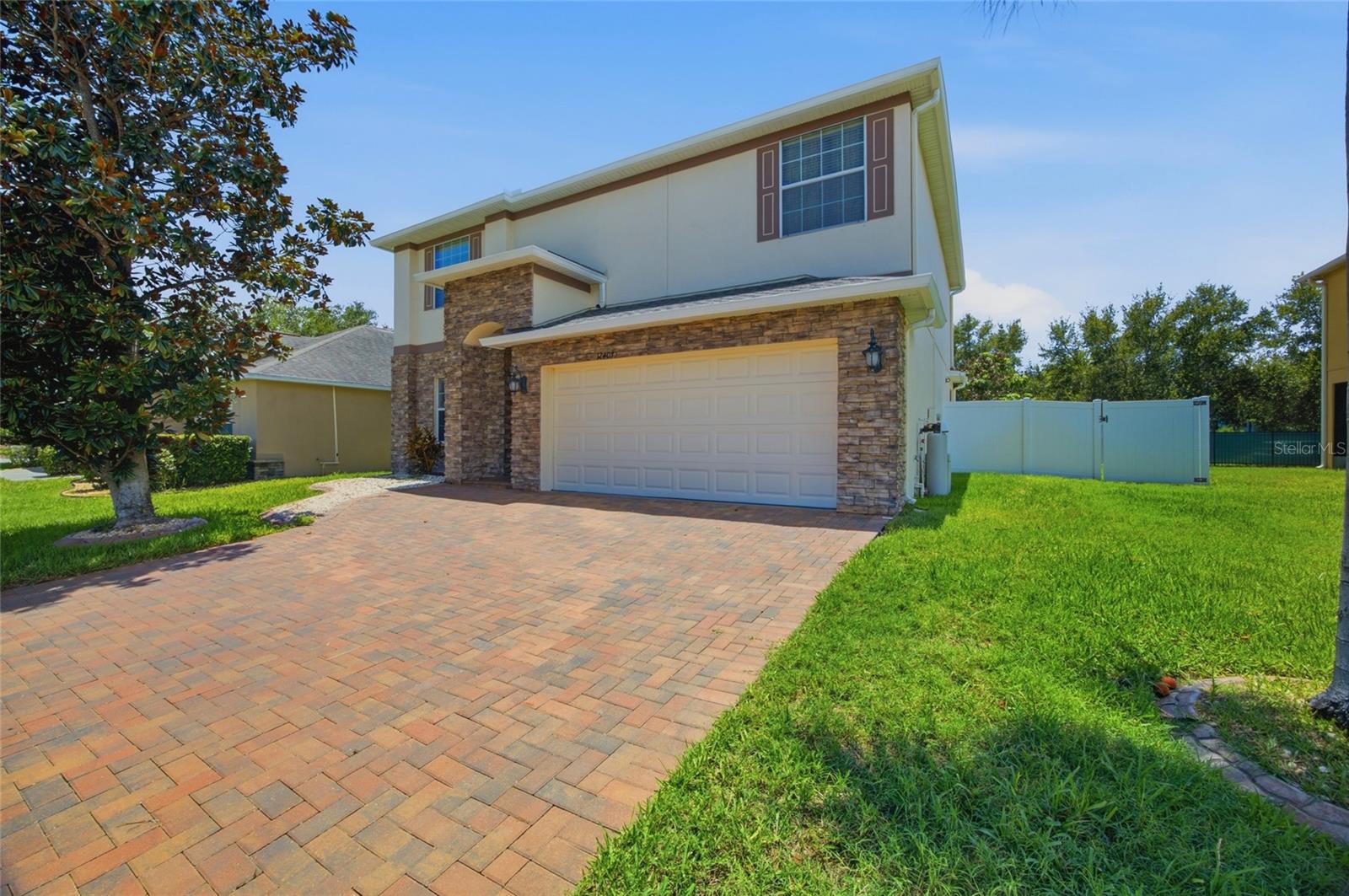 Welcome home to Panther Trace, one of Riverview's most sought-after resort-style community! This beautifully maintained 2,502 sq ft two-story home offers 4 bedrooms, 2.5 baths, and a 2-car garage with custom cabinetry, with major systems already handled - new roof (2025) and new A/C (2026). Inside you'll find updated flooring throughout, a renovated kitchen with solid cabinetry, granite counters, an expanded island (2023), and a designer tile backsplash, plus fully upgraded marble bathrooms (2023). All four bedrooms are upstairs, including a spacious primary suite with a walk-in closet with built-in organizer and a spa-inspired en-suite with dual sinks, walk-in shower, and soaking tub. The backyard is built for entertaining, with a sparkling heated pool featuring dual water features, LED lighting, and a screened enclosure (2020), a stone-accented outdoor kitchen with granite top (2023), paver deck (2020), fruit trees, and vinyl/metal fencing for privacy; additional updates include a new washer (2024) and water softener (2025). Panther Trace offers a lagoon pool, splash park, clubhouse, playgrounds, tennis and basketball courts, walking trails, and an on-site elementary school, with easy access to I-75, Hwy 301, Downtown Tampa, Busch Gardens, and Apollo Beach. Move-in ready and meticulously cared for — schedule your showing today!