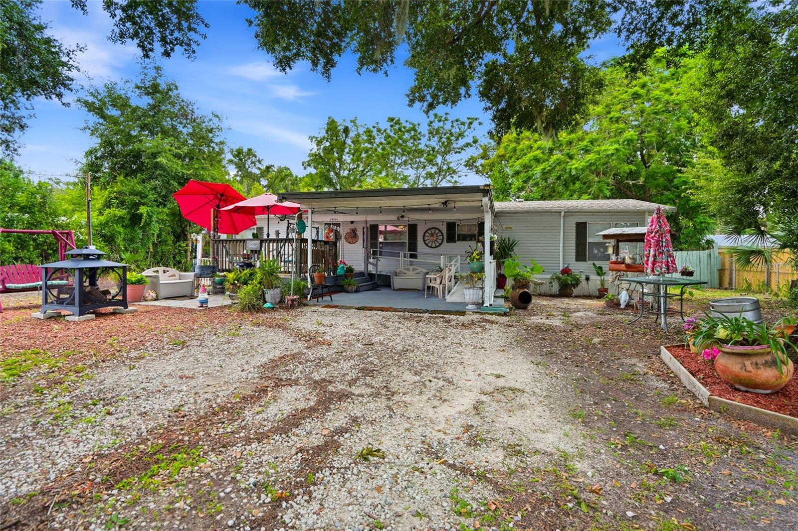 Don't miss this opportunity to own this well-maintained 3-bedroom, 2-bath double-wide mobile home situated on just shy of a half-acre. This home features a desirable split bedroom floor plan, a spacious living room with a cozy wood-burning fireplace, a separate dining area right off the kitchen, and a breakfast nook that you could actually use as a home office, reading area, or hobby room. An inside laundry room complete with a washer and dryer adds everyday convenience. Step outside into your large back porch which can easily be screened in and leads to to your generously sized backyard offering plenty of room to entertain, garden, or simply relax. The detached 2- to 4-car garage/carport provides ample space for vehicles, storage, hobbies, or a workshop. Bring your boat, RV, camper, trailers, and all your outdoor toys. With plenty of parking and room to spread out, this property offers the space and flexibility you've been looking for. Whether you're searching for your next home or an income-producing investment property, this property is an excellent opportunity. Rental demand in this area remains strong, making it an attractive option for investors. As an added bonus, there are no HOA, and no deed restrictions, giving you the freedom to truly enjoy your property. Conveniently located near shopping, restaurants, and I-75, this home offers easy access to everything you need while still providing privacy and room to roam.