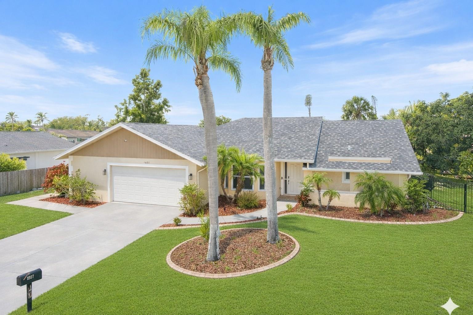 REDUCED!  PLEASE NOTE THE PROPERTY APPRAISER SITE DOES NOT REFLECT THE PERMITTED EXPANSION-ADDITION DONE IN 2016. PLUS THE HOME HAS BEEN FULLY UPDATED. MOVE-IN READY & beautifully updated, this 3-bedroom, 2-bath pool home is tucked away on a quiet private cul-de-sac in the highly desirable Jacaranda West neighborhood—an ideal setting for both full-time residents & seasonal owners alike. With a roof just two years old, fully updated kitchen & bathrooms, refreshed interior paint, updated flooring, & a permitted expansion of the living space, this home offers peace of mind & easy Florida living from the moment you arrive. Pocket sliding glass doors allow entire walls of glass to disappear, opening the home to the outdoors & instantly setting the tone for relaxed, resort-style living. The popular split-bedroom floor plan provides privacy & flexibility, while vaulted ceilings in the kitchen & family room create a light, open atmosphere perfect for everyday living & entertaining. Stylish finishes include luxury vinyl flooring, porcelain tile flooring, & an electric fireplace, adding warmth & charm to the main living space. Step outside through the pocket sliders to a spacious covered lanai that flows seamlessly into the updated paver lanai & resurfaced pool deck, making it easy to enjoy poolside dining, casual gatherings, or quiet mornings with coffee by the pool! The permitted expansion, completed by the seller—a licensed contractor—added approximately 150 square feet of indoor living area, converting the home from a two-bedroom to a three-bedroom layout & incorporating an indoor laundry room with sink. An oversized garage with room for a golf cart offers excellent storage & everyday convenience. Set on a private-feeling 10,000+ square-foot lot with mature tropical landscaping, the property enjoys public water & sewer, along with a low annual HOA of just $550, designed to keep the neighborhood attractive while remaining easygoing & resident-friendly. The family-friendly neighborhood is within an excellent school district, the home is close to top-rated schools including Garden Elementary, Venice Middle School, Venice High School, & access to the nationally recognized Pine View School for the Gifted. Everyday shopping, dining, & medical services are just minutes away, with Sarasota Memorial Hospital’s Venice campus nearby, quick access to I-75, & less than 10 minutes to have your toes in the sand at the beautiful beaches of Venice Island & Nokomis. Whether you’re searching for a full-time family home or the perfect winter retreat, this inviting property truly delivers the best of the Florida lifestyle.