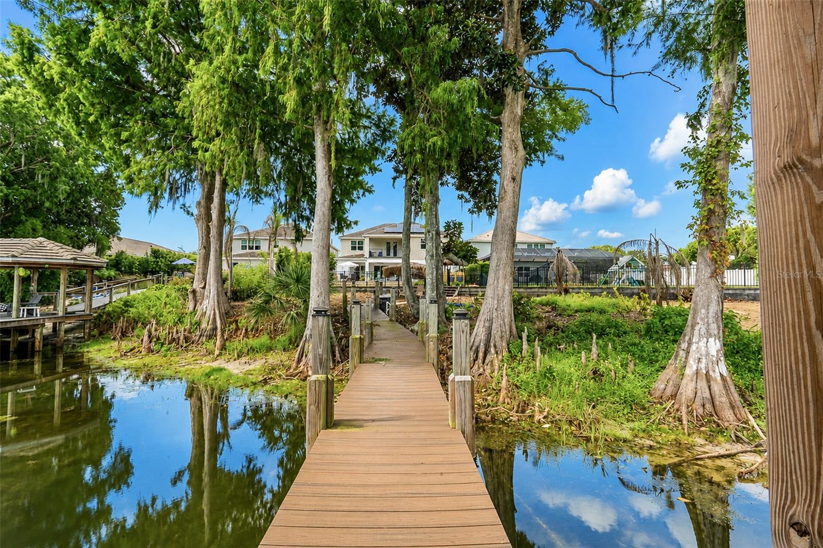 Welcome to an exceptional lakefront home in the gated community of Lake Florence Preserve, where luxury, space, and lifestyle come together in the heart of Winter Park. This stunning 6-bedroom, 5+ bath pool home sits on the shores of private, Lake Florence, offering a rare opportunity for true waterfront living.
Step inside to a grand two-story entry with soaring 10-foot ceilings and an open-concept layout designed for effortless entertaining. Natural light fills the expansive living, dining, and kitchen spaces, highlighting the home’s high-end finishes and thoughtful design.
At the center of the home is a chef’s kitchen featuring an oversized 11’ x 5’ island, gas range with vent hood, premium Samsung and GE appliances, and an impressive 10’ x 4’ walk-in pantry, perfect for hosting or daily convenience.
With six generously sized bedrooms, including a private in-law suite, this home offers flexibility for multigenerational living or guests. Upstairs, the spacious primary suite boasts lake views, a large ensuite bath, and dual walk-in closets. You’ll also find a versatile 19’ x 18’ game room with a 17' wide balcony overlooking the pool and lake, along with an oversized second-floor laundry room.
Outdoor living is where this property truly shines. Enjoy direct access to Lake Florence from your private dock with electric boat lift, ideal for boating, jet skiing, or peaceful sunset cruises. The backyard is designed for relaxation and entertaining, complete with a saltwater pool, fully fenced yard, tiki hut featuring an outdoor kitchen and outdoor shower fitted with hot and cold water.
Additional highlights include a 3-car garage, tankless water heater, custom closets throughout, and upgraded lighting and ceiling fans.
Ideally located just minutes from SR 436, the 417, and only 15 minutes to Park Avenue, this home offers both convenience and exclusivity within a sought-after gated community.
This is a rare opportunity to own a true lakefront retreat. Schedule your private showing today.