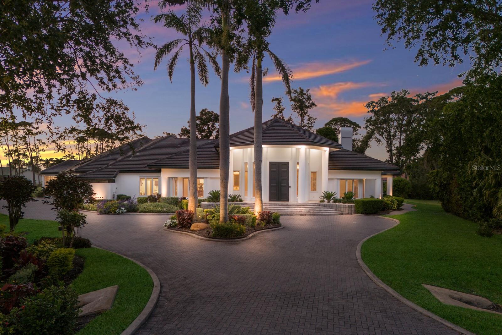 Nestled within the exclusive gated community of the Oaks Club in Osprey, Florida. This singular estate represents a masterful confluence of architectural refinement and modern luxury, encompassing nearly 7000 ft.² of conditioned living space, the residence has undergone an extraordinary transformation – reflecting an investment exceeding $1.5 million – to achieve a standard of craftsmanship seldom encountered in contemporary homes. The grand foyer reimagined with architectural restraint and elegance, opens to a series of impeccably curated, living spaces defined by scale, light and material integrity. The entire home has been freshly repainted, presenting a pristine, harmonious aesthetic that enhances the interplay of color, texture and light throughout. The kitchen rebuilt from its foundation up is a tour de force of design and function-anchored by bespoke ultra-custom cabinetry, expansive, quartz surfaces, and a suite of professional grade Thermador appliances. These include three wall, ovens a speed-cook microwave, an induction cooktop, dual dishwashers, two wine coolers, a U-line beverage refrigerator, and an impressive new side by side Thermador refrigerator and freezer. Every culinary and social experience is elevated by thoughtful details such as Newport Brass fixtures, elegant chandeliers, and an exceptional walk-in pantry that unite beauty and practical design. The primary suite embodies serene granuer, featuring a newly constructed bath with custom cabinetry, a sculptural freestanding tub, and dual shower-all finished in large format, porcelain tile. A remarkable walk-in closet includes a concealed storage and safe room, melding security with sophistication. Two additional bedroom suites have been fully redesigned with its own private bath, while a refined powder room enriches the main entry corridor.  Throughout the home, state- of-the-art technology complements the elegant aesthetic, a newly installed security system with outdoor surveillance cameras, ensures peace of mind, while a Sonos sound system, integrates premium audio, seamlessly across living areas for both entertainment and ambience. Additional appointments include new hardwood flooring, freshly refinished and painted garage spaces with an epoxy-coated floor, and a large air-conditioned storage room with supplementary washer, dryer hook ups. The outdoor domain has been equally vitalized, showcasing, a newly remodeled pool, upgraded mechanical systems, and beautifully landscaped grounds that frame the home with natural grace and meticulous attention to detail. Residing within the Oaks Club, homeowners enjoy the exclusivity of one of Sarasota County’s, most distinguished country club communities renowned for its championship golf courses, fine dining, tennis and social amenities. This one-of-a-kind Eagle Watch Lane estate stands as a testament to discerning design, meticulous, stewardship, and enduring architectural grace.