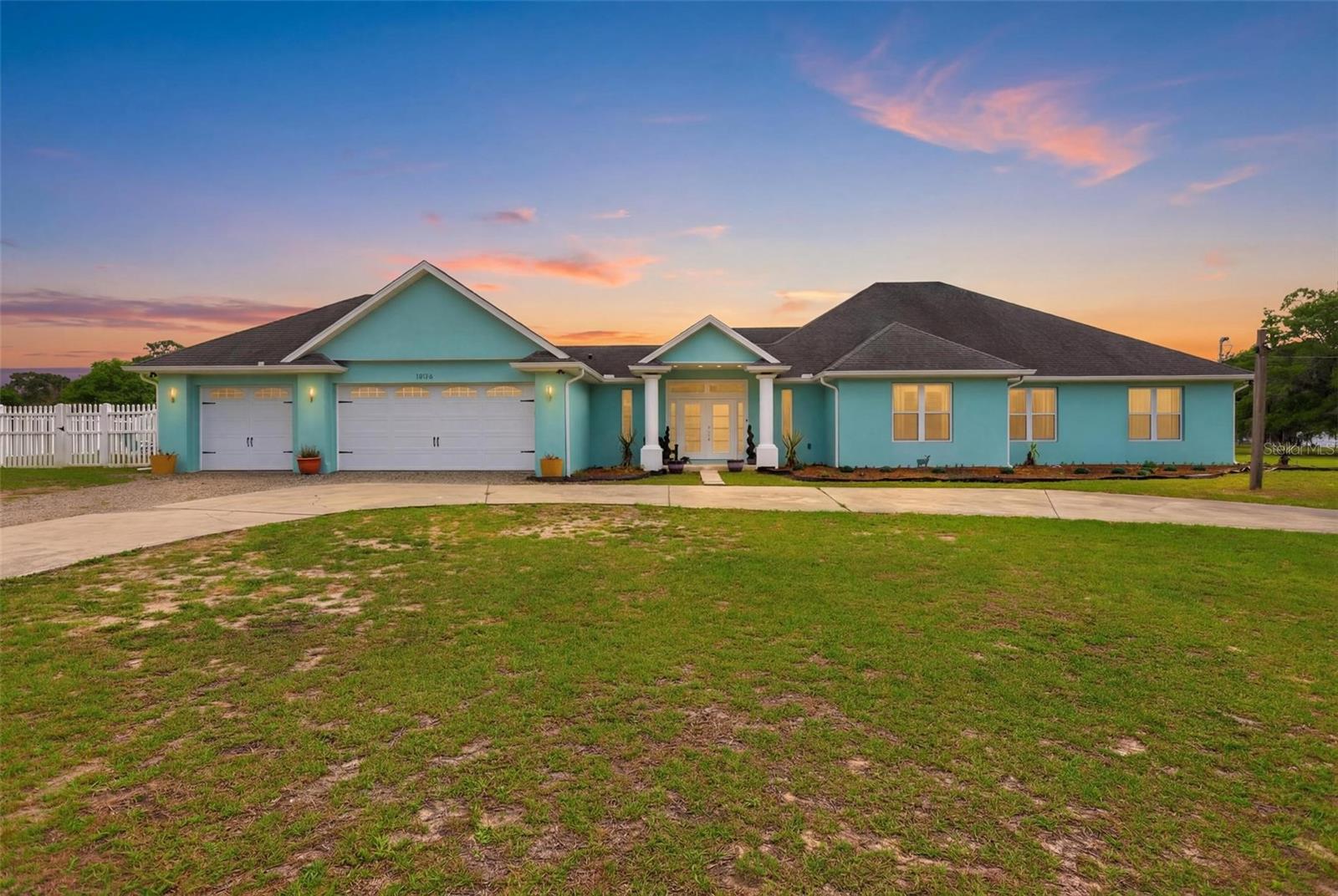 Experience the pinnacle of luxury in this 2023-built ranch estate, perfectly situated on 3 private acres in DeLand with NO HOA. This sprawling 5-bedroom, 2.5-bathroom sanctuary offers nearly 3,500 square feet of modern elegance, featuring seamless porcelain tile throughout, a versatile sunroom, and a massive 3-car garage. Bathed in natural light with oversized windows and upgraded light fixtures, this home feels open, bright, and welcoming from every angle. The gourmet kitchen delivers elevated designer finishes with quartz countertops, 42" cabinets, gold hardware, a wine fridge, matching stainless steel appliances, and room for plenty of entertaining with the eat in space and breakfast bar. The primary suite is expansive and includes a sitting lounge, his and hers closets, and a spa-inspired en-suite bathroom with thoughtful upgrades throughout, including dual vanities and a Jacuzzi tub.  Step outside to your personal oasis, where a pristine in-ground pool, duck pond, expansive patio, pergola, and vinyl fenced yard await—all providing the ultimate backdrop for Florida living at its finest. Standout features also include a stunning indoor laundry room, a 12x30 shed that is prewired to be an in law unit, and new well and septic installed in 2023, along with all appliances and core systems of the home for true peace of mind.  This rare combination of new construction, acreage, and premium amenities won't last long— be sure to ask about the potential for addition parcels on the property for a true multi generational compound. Call today to schedule your private showing and see this spectacular home in person!