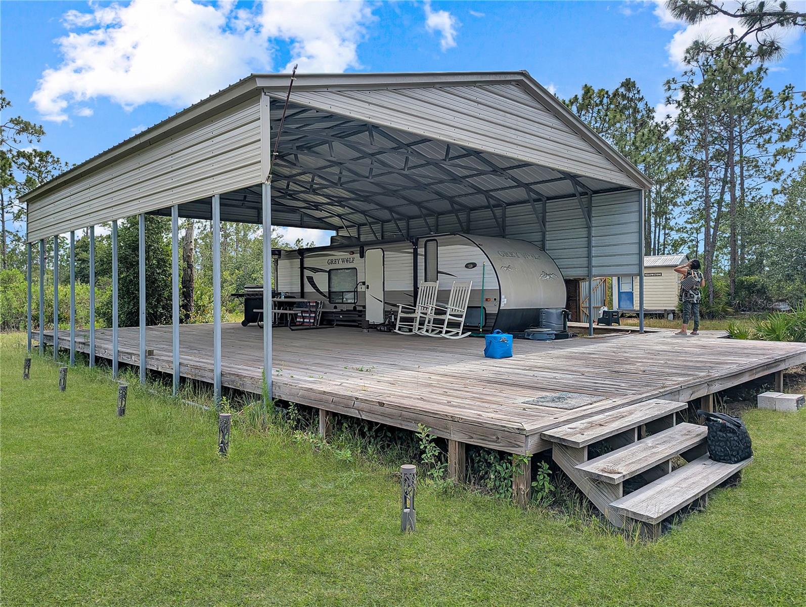 Escape to your own outdoor paradise! Situated on 2.5 acres, this fully equipped recreational retreat includes a 2015 Grey Wolf camper with A/C, full kitchen, bath, queen bedroom, and additional sleeping accommodations. A spacious covered 30' x 60' deck, standalone bathhouse, and utility shed provide everything needed for comfortable weekend getaways. With access to countless acres of wilderness and miles of trails, hunting, fishing, ATV riding, and off-road adventures are right at your doorstep. The perfect base camp for outdoor enthusiasts seeking peace, privacy, and endless recreation. 4-Wheel Drive Required to Access the Property.