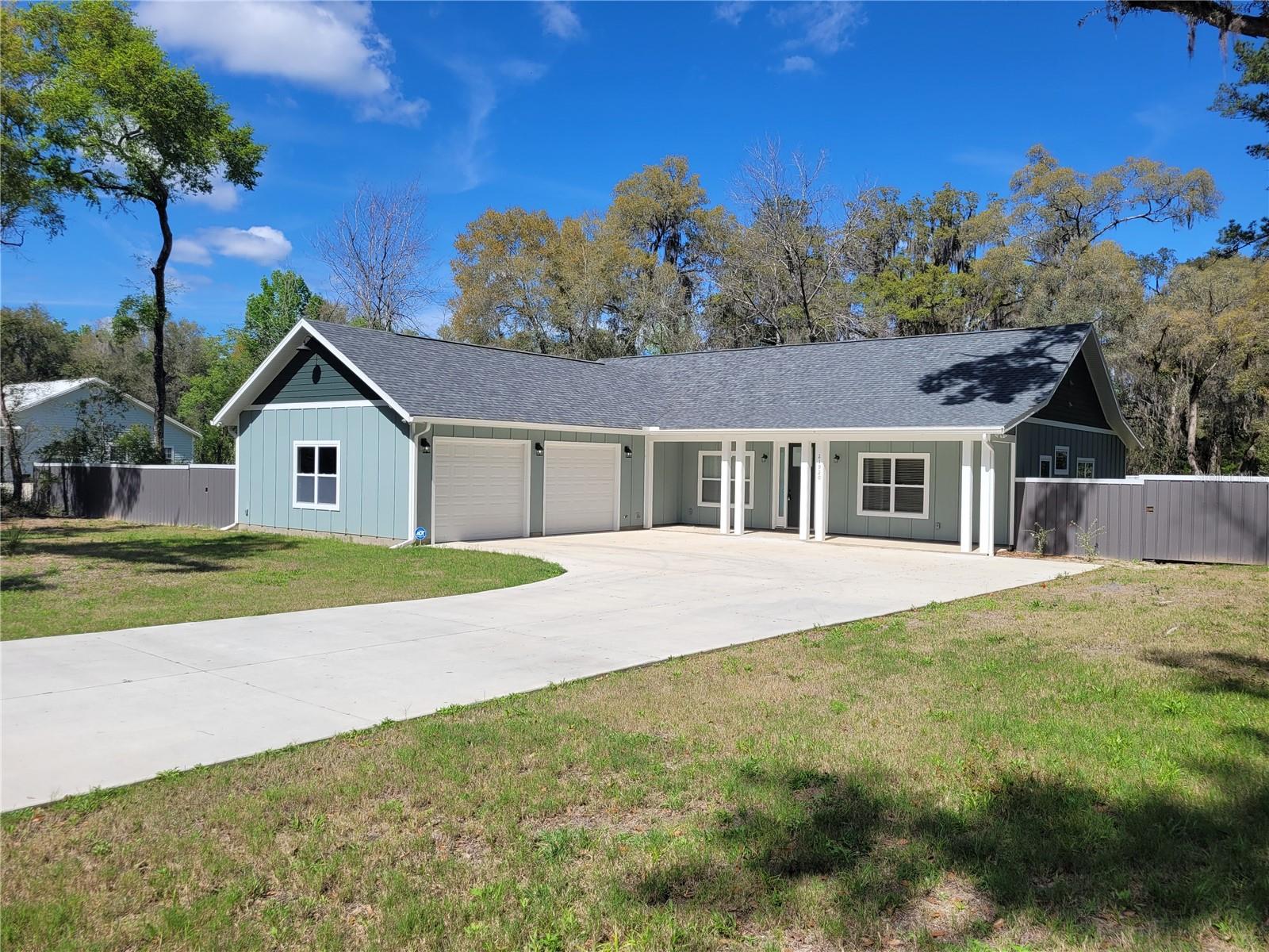 Spacious 4 bedroom, 2 bathroom home with an oversized 2 car garage in the beautiful non HOA community of Lakeshore Gardens. Located on a large 1 acre lot directly off of a paved road. Lakeshore Gardens is the home of Lake Jeffords, a 160 acre private lake. Step foot inside to an open living room/dining room combo with a cathedral ceiling. The kitchen has custom cabinetry, quartz counter tops, coffee bar, pantry, and a breakfast nook with large windows overlooking the back yard. All 3 guest bedrooms feature large walk in closets and have plenty of natural light. The guest bathroom features a tub/shower combo with a double vanity, also with matching quartz countertops. The large master bedroom has a tray ceiling and a large master bathroom/closet. The master bathroom has a spa like feel including an oversized double vanity with quartz counter tops and a huge walk in shower. Home includes many upgrades such as luxury vinyl plank flooring, 8ft doors through-out, 9 ft. ceilings in the guest rooms/bathrooms/laundry, double doors opening from the living room out to the lanai, and electrical outlets with USB ports throughout. All new Appliances in Kitchen. Rear yard is fully fenced and very private. Schedule your showing today! Seller Motivated!!