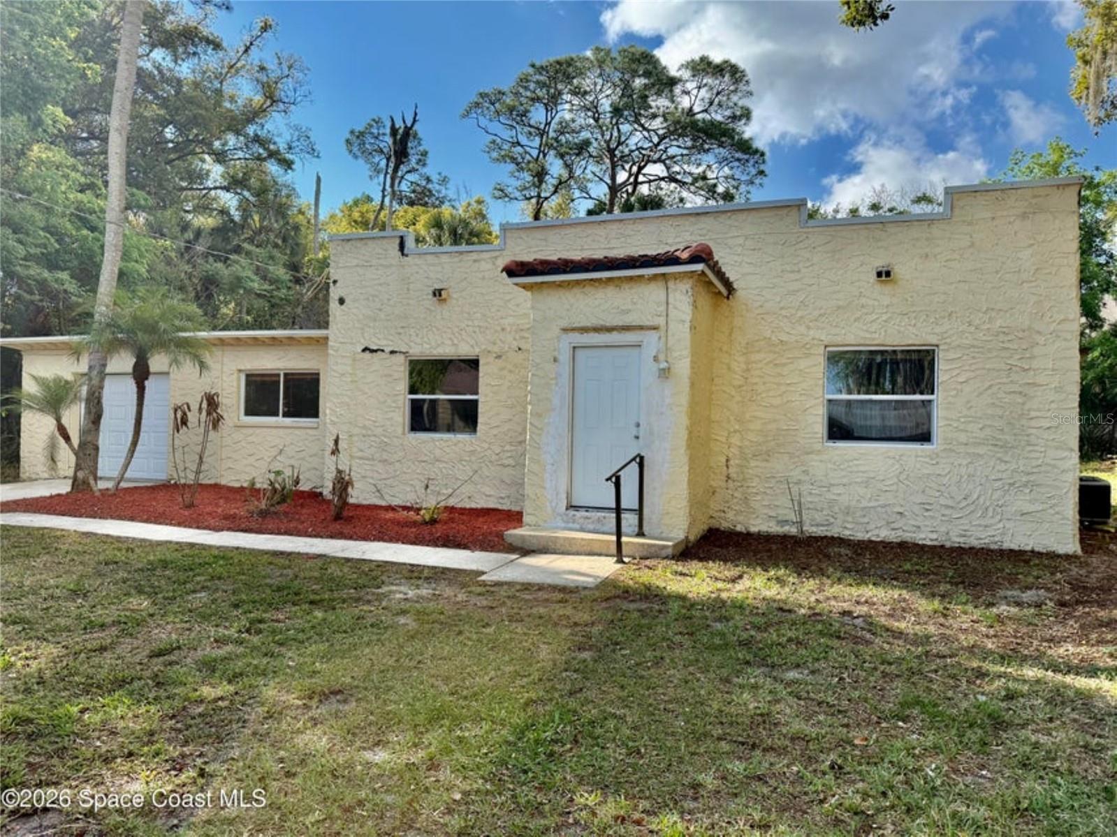 This three bedroom, two bath home is located in the heart of central Titusville. Home sits on almost a third of an acre lot which is fenced. The home features a split floor plan for added privacy, a spacious living room with a cozy fireplace and dedicated dining area perfect for gatherings. The kitchen has ample space for cooking and storage. Additional highlights include a one car detached garage with two over head doors located on each end of garage. It's generous yard and convenient central location is close to shopping, schools, major roadways and government agencies