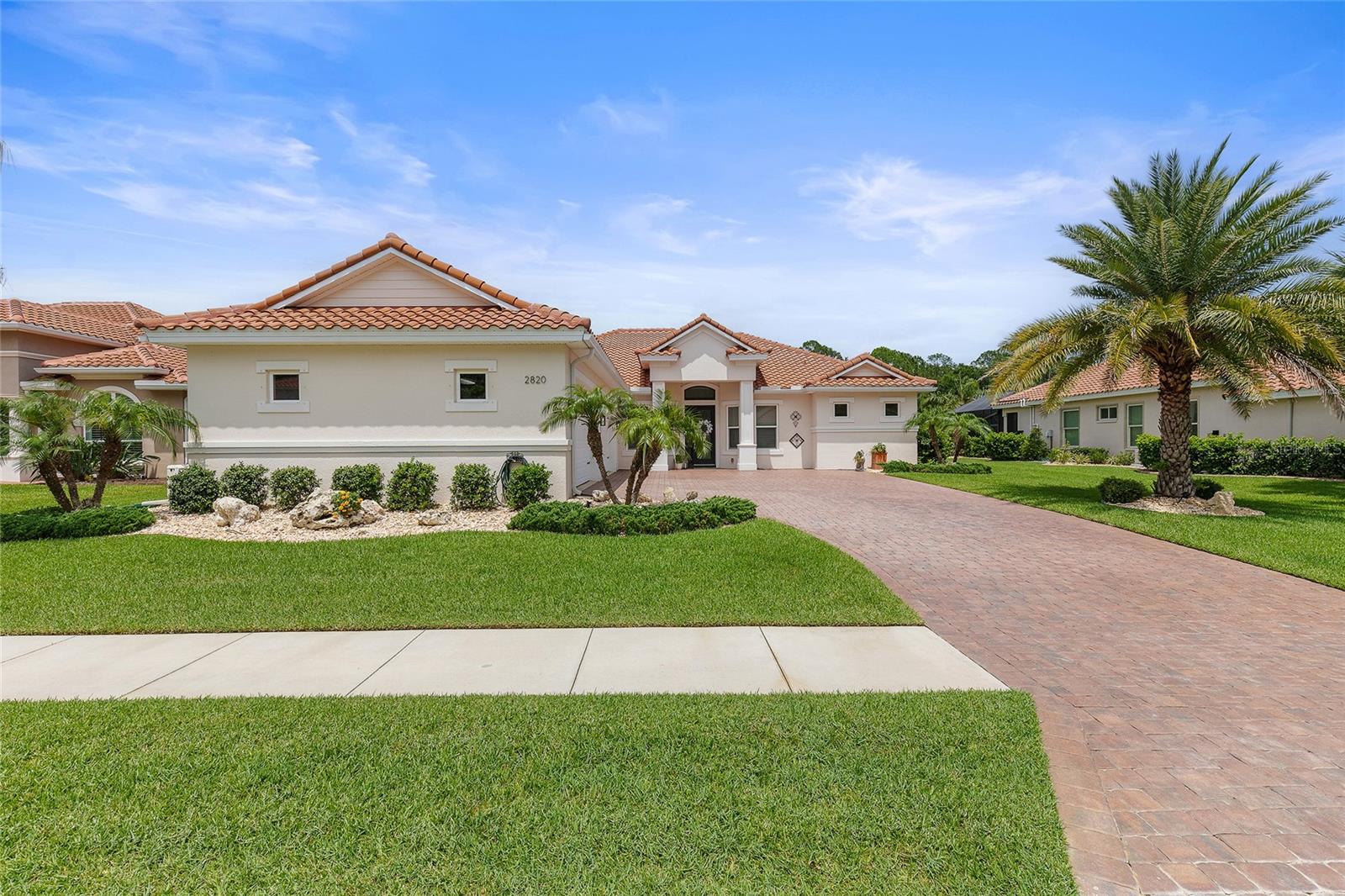 Welcome home to this immaculate Paytas custom built residence, showing 3 bedrooms, large office or 4th bedroom, 3 full bathrooms and an 800 square foot 4-car air conditioned  garage. Included also is a whole home Generac generator, for those stormy evenings...never lose your power! This house is ideally suited for both everyday living and sophisticated entertaining, anchored by a light filled great room that flows seamlessly through hidden sliding glass doors to the outdoor panoramic living room directly on the golf course with spectacular views. The gourmet kitchen is a chef's showcase appointed with all brand new Thermador appliances including a gorgeous gas range with 6 burners, a griddle, silent dishwasher and convenient microwave drawer, also a  high-end brand new counter-depth refrigerator. Custom gleaming white coastal style kitchen cabinets, pull out mixer cabinet for all you Bakers, sleek quartz countertops with 2 kitchen islands. The "party island" easily seats 6, the casual dining nook seats 8 and the formal dining room seats 6-12 depending on how big your party is! The main primary bedroom suite is a private retreat secluded in the south wing of the house, with 2 separate custom closets by California Closets. The spa-inspired bathroom has dual sinks, all cabinets have custom pull-outs for easy access. The walk in shower has multiple shower heads, walk in easy entry for true privacy. Separate toilet room. Additionally there is a secondary primary suite that easily could be a private Mother-In-Law space with a large walk-in California Closet system, easy entry shower for wheel chair access if needed.  Dual primary suites allow hosting overnight guests very comfortably. Private exit to the large screened lanai. For your furry companions, multiple discreet doggy-doors for your pet to easily access the fully fenced yard and dog run. Remember....zero carpet! This location in New Smyrna Beach offers access to an unmatched lifestyle with a golf course right outside your back gate. The Club at Venetian Bay has an 18 hole championship golf course known for its links-style design and generous fairways and mounding's. Inside the Golf Clubhouse is an outstanding bar and restaurant. A fitness center and miles of paved walking trails are also a great part of the community, which is also golf-cart friendly! Rounding out this is a membership required resort style lagoon pool with the Tiki Cove bar and Grill with a great happy hour, live music and just a golf-cart ride away. And do not forget Bistro 424 for the most amazing pizza (get the Gibroni) with craft cocktails and gorgeous views and outdoor seating around the fountain. Literally 15 minutes to our world class SURFING BEACH! You can drive on our beaches which is amazing in itself. White sand, fishing, and fun Flagler Avenue with chill restaurants as found on Guy Fieri's Diners Drive-Ins and Dives!!! So are you ready for an amazing future...come play and live the NSB dream...!!!
