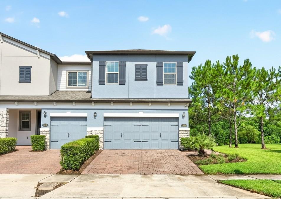 Seller may consider buyer concessions if made in an offer ~ Welcome to Econ Landing, where this beautifully UPGRADED 3-bedroom, 2.5-bath END-UNIT townhome offers over 1,700 square feet of thoughtfully designed living space, designer finishes, and a premium homesite with peaceful CONSERVATION & POND VIEWS! Built in 2019 and meticulously maintained, this home feels like new while delivering the LOW MAINTENANCE LIFESTYLE you have been searching for. Recent updates make this home truly stand out, including a LAUNDRY ROOM REFRESH (2025) with added cabinetry and stylish backsplash, a PRIMARY SUITE REFRESH (2025) featuring a designer batten accent wall and fresh paint, (2024/2025) second bedroom upgrades with fresh paint, chair rail, picture frame molding and a custom closet system, a WATER SOFTENER (2024), LUXURY VINYL PLANK FLOORING throughout the entire second floor and staircase (2023), a built-in office/workstation in the loft (2023), a 240V outlet in the garage for EV CHARGING (2022), and timeless CROWN MOLDING THROUGHOUT along with the EXTENDED SCREENED LANAI, both completed in (2019). From the moment you arrive, the attractive landscaping, paver driveway, 2-CAR GARAGE and desirable end-unit location create exceptional curb appeal. Inside, WOOD LOOK TILE flows throughout the main living areas while the luxury vinyl plank flooring extends across the entire second floor, offering a completely carpet-free interior. The OPEN CONCEPT layout seamlessly connects the living, dining and kitchen spaces, while sliding glass doors lead to the extended screened lanai where you can relax, entertain or simply enjoy the private conservation backdrop and water views. The kitchen combines style and function with STAINLESS STEEL APPLIANCES, sleek granite countertops, SUBWAY TILE BACKSPLASH, upgraded hardware and fixtures, abundant storage and a window above the sink that fills the space with natural light while showcasing the peaceful views. Upstairs, the SPLIT BEDROOM layout provides ideal privacy. Your generous PRIMARY SUITE is positioned at the front of the home and offers endless natural light, a WALK-IN CLOSET and a well-appointed en-suite bath. Bedrooms two and three are at the back of the home with a shared full bath, while the centrally located LOFT features the CUSTOM BUILT-IN OFFICE, creating the perfect work-from-home setup or flexible bonus space. Residents of Econ Landing enjoy a COMMUNITY POOL, playground, green space and covered picnic area, all in a convenient East Orlando location with quick access to SR 417, SR 408, Curry Ford Road and Alafaya Trail. You are just minutes from Orlando International Airport, Lake Nona and Medical City, Downtown Orlando, Waterford Lakes Town Center, Lee Vista, Avalon Park, shopping, dining and recreation. No detail has been overlooked! With its premium end-unit location, private wooded and pond views, thoughtful upgrades and unbeatable convenience, Econ Landing truly welcomes you HOME. Call today to schedule a private tour!